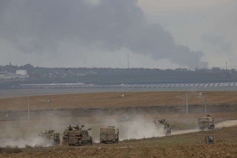 Israeli army vehicles move near the Israeli Gaza border, southern Israel, Monday. The militant Hamas rulers of the Gaza Strip carried out an unprecedented, multi-front attack on Israel at daybreak Saturday.
