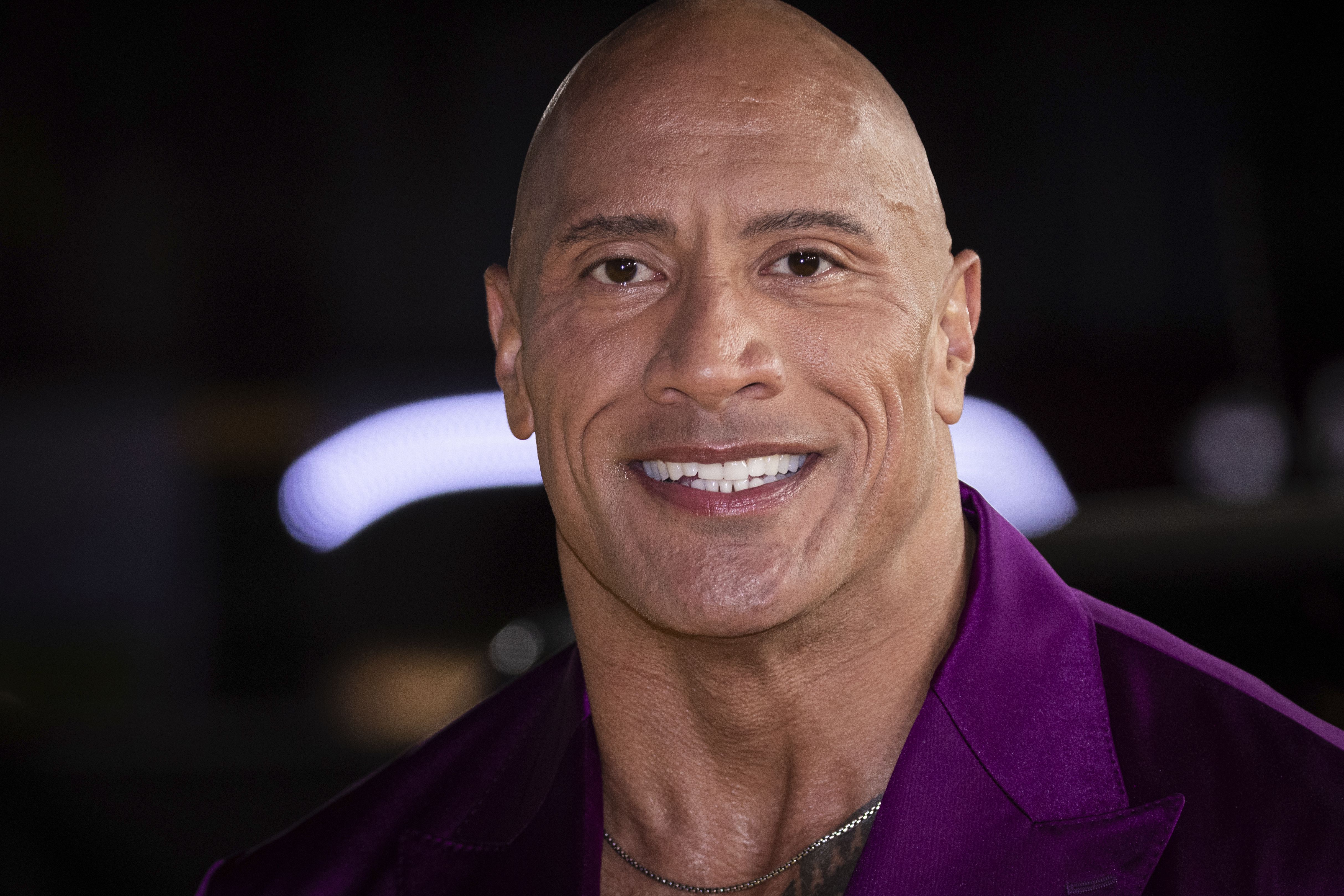 Dwayne Johnson, aka The Rock, poses for photographers upon arrival for the premiere of the film “Black Adam” on Oct. 18, 2022, in London. Johnson and Oprah Winfrey each donated $5 million to start a fundraiser to benefit folks who'd been burned out of their homes in the Maui wildfires. 
