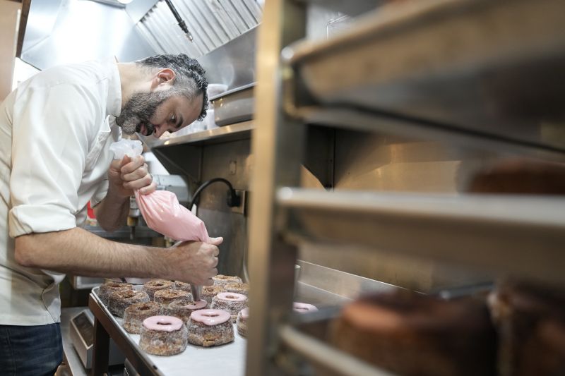 Dominique Ansel ices Cronuts before the opening of his namesake bakery in New York, Sept. 28. In 2013, before most people knew the term “going viral,” the French pastry chef created the Cronut, a cross between a croissant and a doughnut, at his newly opened New York bakery.