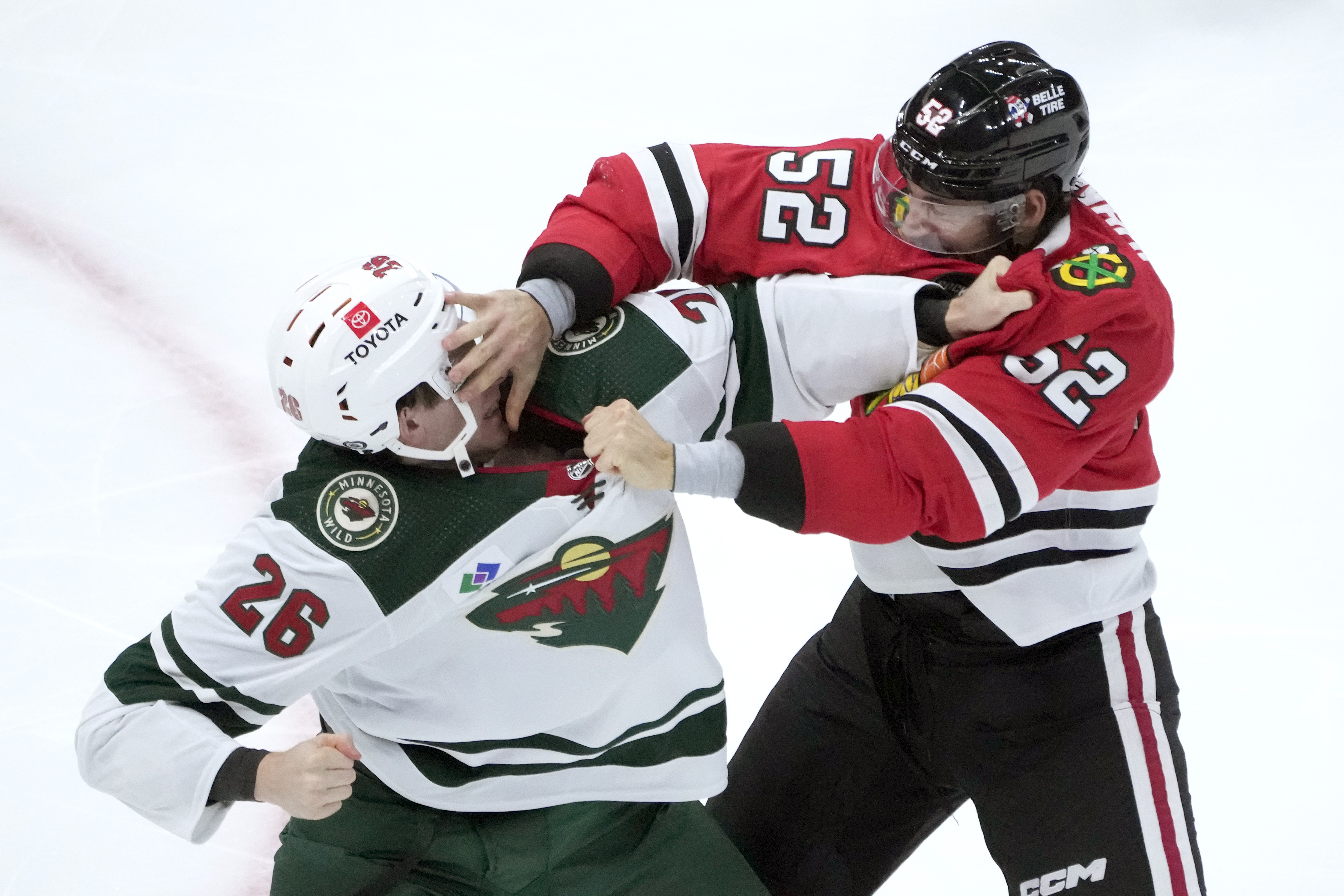Chicago Blackhawks center Reese Johnson, right, and Minnesota Wild center Connor Dewar fight during the second period of an NHL preseason hockey game Thursday, Oct. 5, 2023, in Chicago.