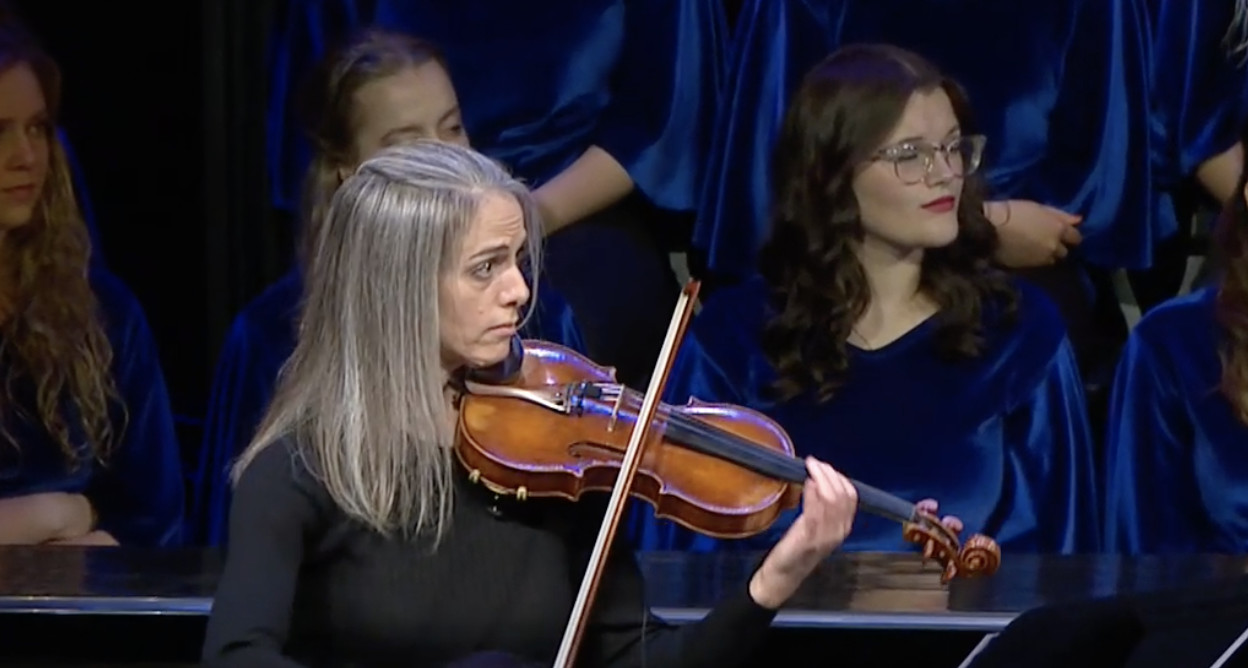 BYU-Idaho violin professor Rebecca Roesler performs “Savior, Redeemer of My Soul” with the BYU–Idaho Combined Choirs and Symphony Orchestra at the inauguration of President Alvin F. Meredith at the BYU-Idaho Center in Rexburg, Idaho on Tuesday.