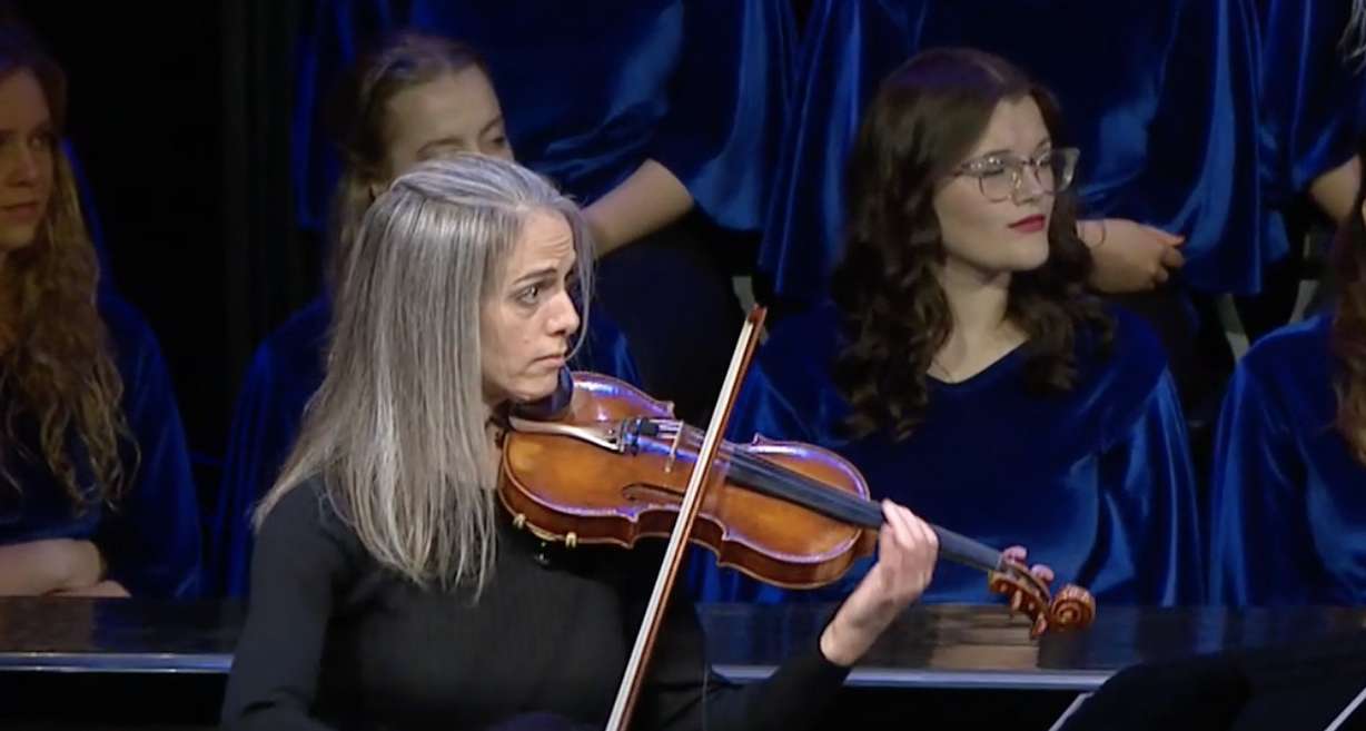 BYU-Idaho violin professor Rebecca Roesler performs “Savior, Redeemer of My Soul” with the BYU–Idaho Combined Choirs and Symphony Orchestra at the inauguration of President Alvin F. Meredith at the BYU-Idaho Center in Rexburg, Idaho on Tuesday.