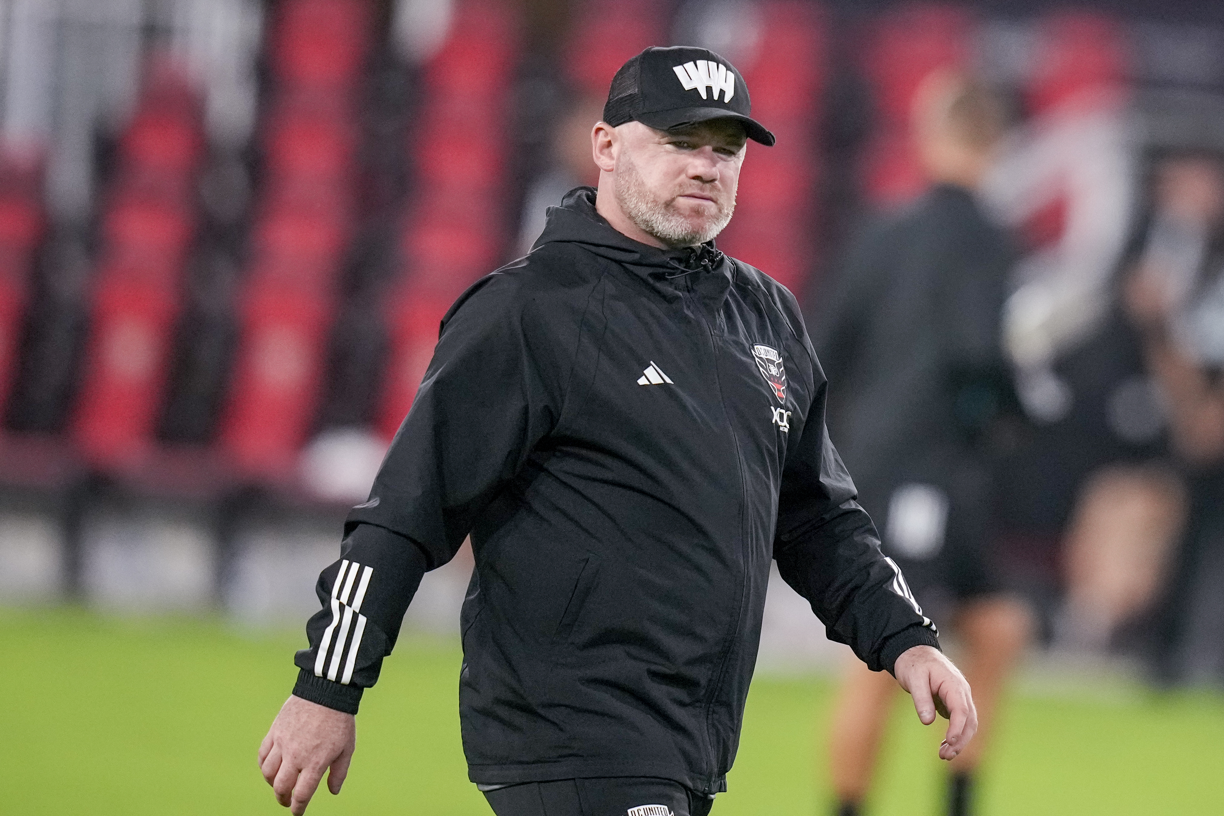 FILE - D.C. United head coach Wayne Rooney walks off the field after the team's MLS soccer match against Inter Miami, July 8, 2023, in Washington. Rooney is out as coach of D.C. United after one season, the team said. Despite the club falling short of the 2023 MLS Cup Playoffs, Rooney improved D.C. United’s point tally in his only full season at the helm. 
