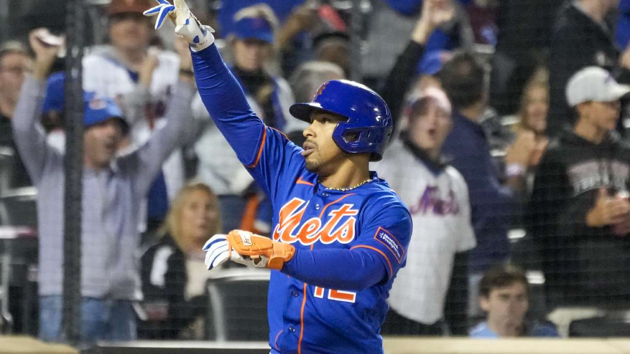 New York Mets' Francisco Lindor reacts at home plate after hitting a two-run home run during the fourth inning of the second game of a baseball doubleheader against the Philadelphia Phillies, Saturday, Sept. 30, 2023, in New York.
