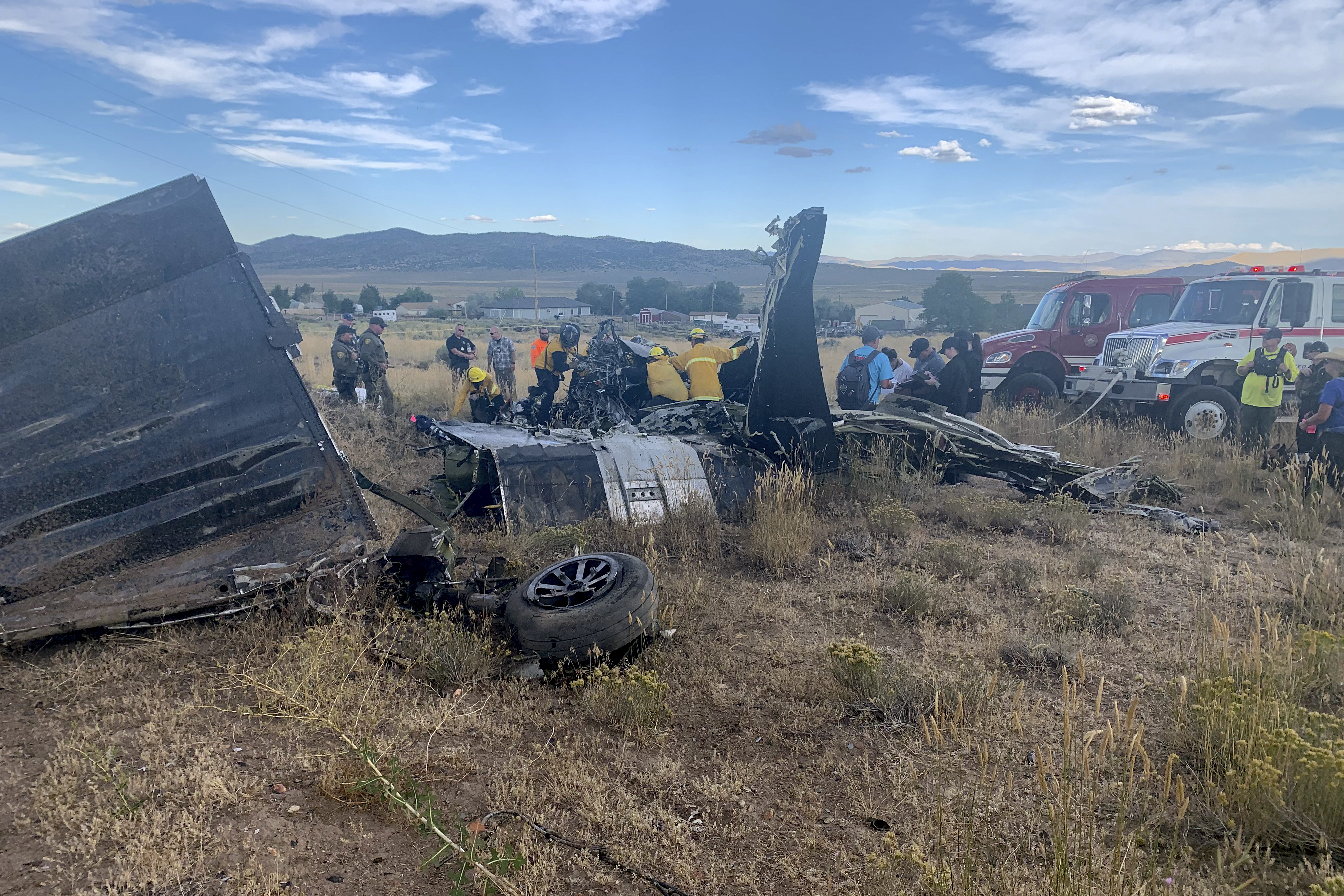 FILE - In this photo provided by Truckee Meadows Fire & Rescue, in Reno, Nev., members of Truckee Meadows Fire & Rescue and other officials look over aircraft wreckage, Sunday, Sept. 17, 2023, in Reno, after two California pilots were killed when their planes collided in mid-air while preparing to land after completing a race at the National Championship Air Races north of the city. A preliminary investigation suggests there was confusion among pilots just before a fatal mid-air collision at the National Championship Air Races last month but sheds little light on what precipitated it as they were preparing to land at Reno-Stead Airport. Adam R. Mayberry/Truckee Meadows Fire & Rescue via AP, File)