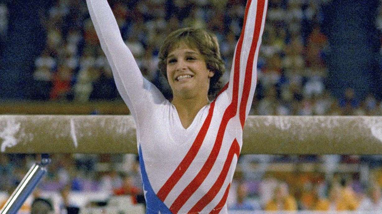 FILE- Mary Lou Retton reacts to applause after her performance at the Summer Olympics in Los Angeles on Aug. 3, 1984. Retton. 55, is in intensive care in a Texas hospital fighting a rare form of pneumonia, according to her daughter McKenna Kelley.