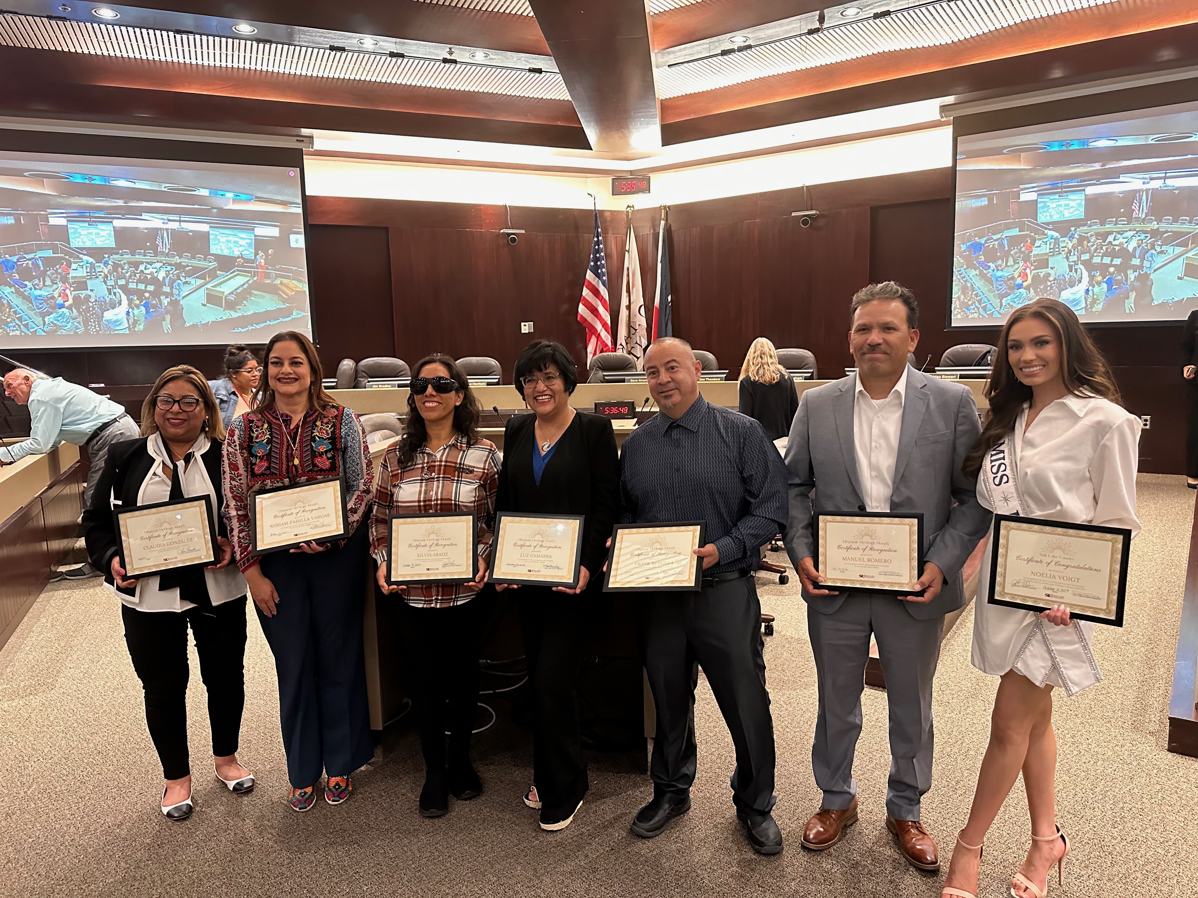 Claudia Gonzalez, Miriam Padilla Vargas, Silvia Araoz, Luz Gamarra, Frank Bedolla, Pastor Manuel Romero and Noelia Voigt at the Salt Lake County Council Chambers Tuesday after accepting recognition for their impact in the Hispanic community.
