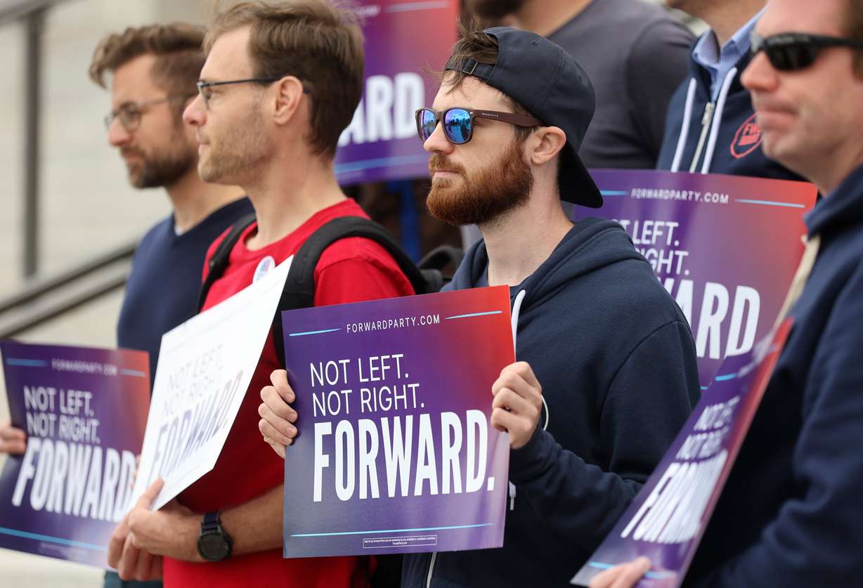 Supporters hold signs during a press conference to announce Utah Forward Party’s collection of more than 2,000 petition signatures, which is required to put the party on voting ballots, outside of the Capitol in Salt Lake City on Wednesday.