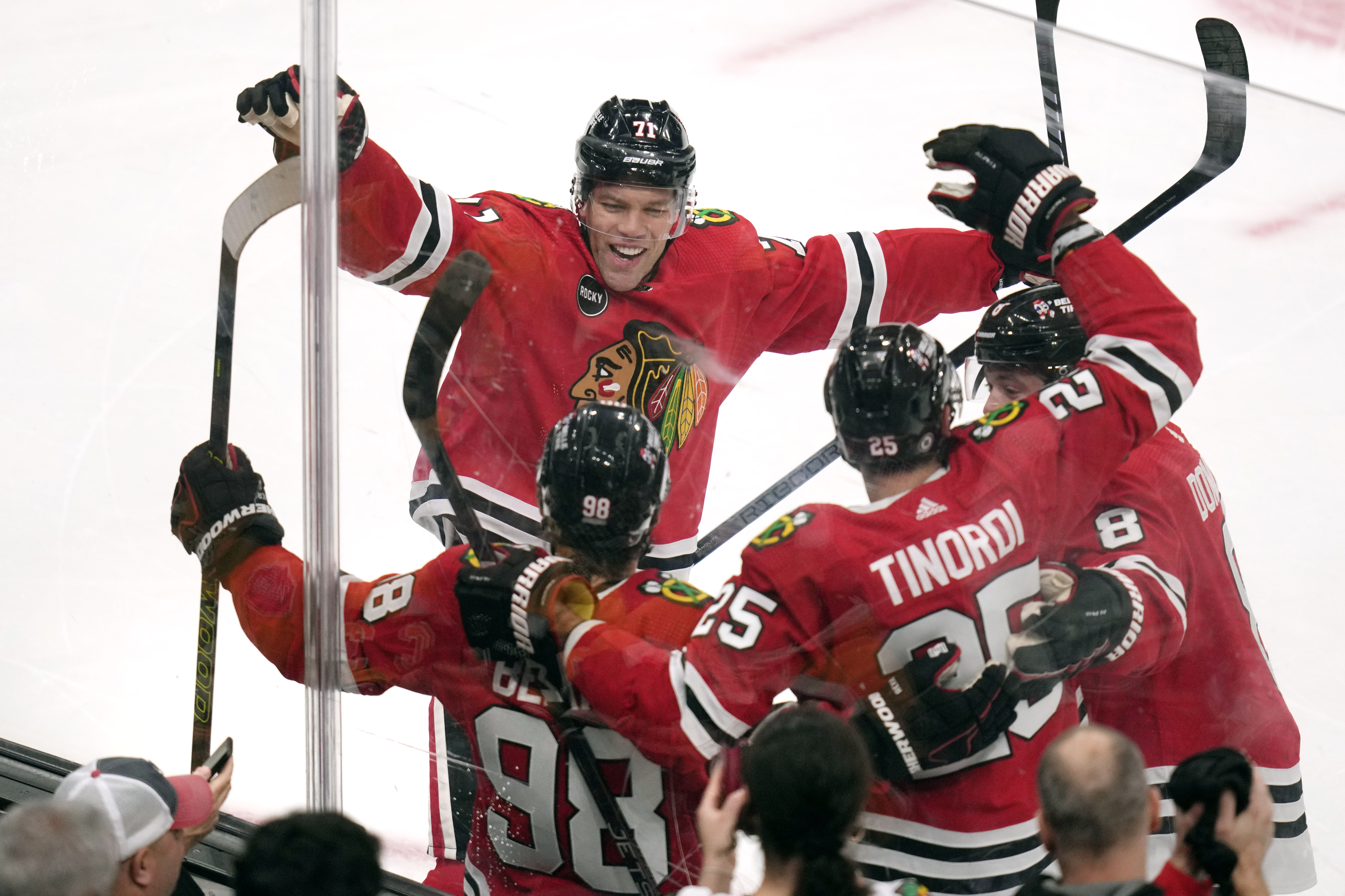 Chicago Blackhawks center Connor Bedard (98) is congratulated by teammates after his goal against the Boston Bruins during the first period of an NHL hockey game Wednesday, Oct. 11, 2023, in Boston.