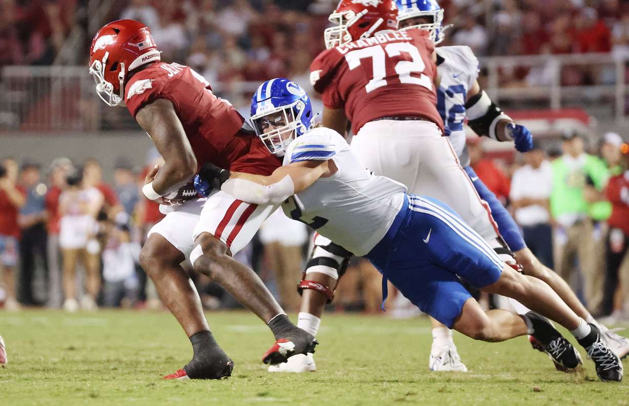 Brigham Young linebacker Ben Bywater (2) tries to sack Arkansas Razorbacks quarterback KJ Jefferson (1) at Razorback Stadium in Fayetteville on Saturday, Sept. 16, 2023. BYU won 38-31.