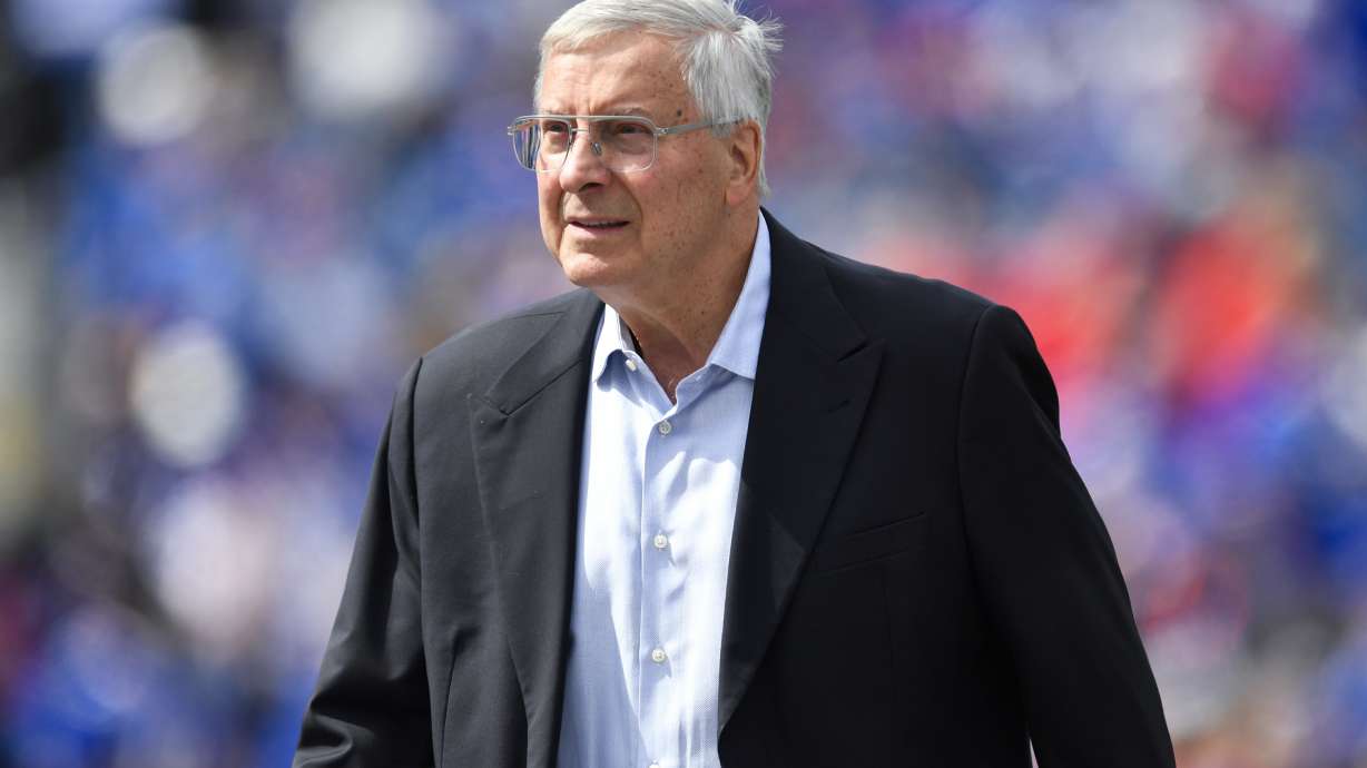 FILE - Buffalo Bills co-owner Terry Pegula walks on the field before the team's NFL football game in Orchard Park, N.Y., Sept. 17, 2023. John Roth, the newly appointed chief operating officer of the Bills and the NHL's Buffalo Sabres, was fired Wednesday along with the Bills' general counsel, Kathryn D’Angelo, because the two were in a romantic relationship, a person briefed on the matter told The Associated Press. Roth had been appointed COO of the Bills in July following a management shakeup involving both teams, which are owned by Terry and Kim Pegula. In a joint telephone interview with The AP, Roth and D'Angelo confirmed they were dismissed without going into detail.