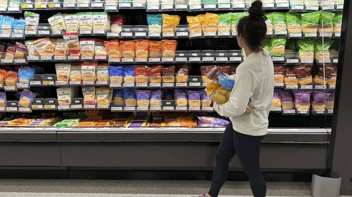 A shopper peruses cheese offerings at a Target store Oct. 4, in Sheridan, Colo. Measures of U.S. inflation in September showed that the pace of price increases is still grinding lower, though at a slow and uneven pace.