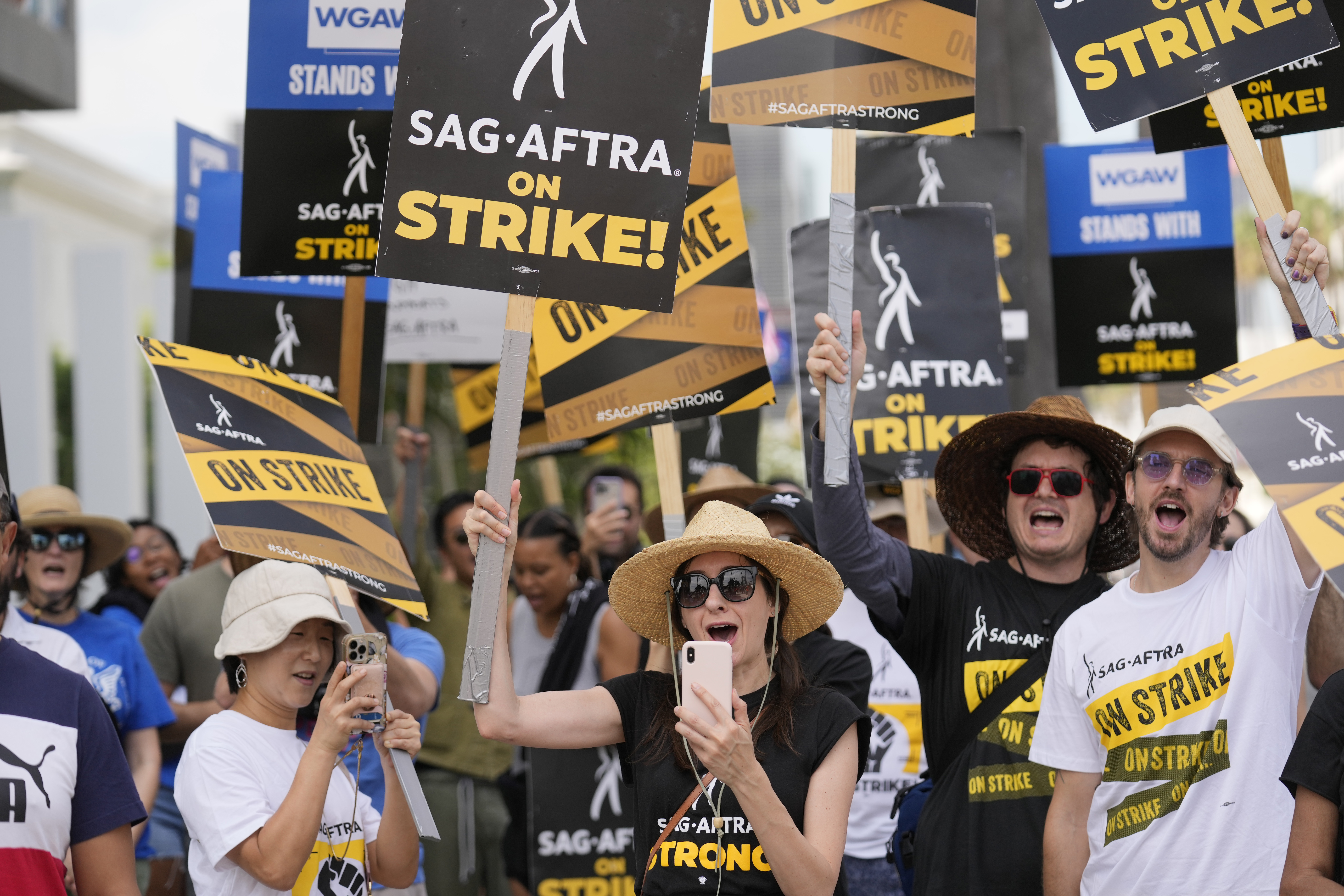 Picketers carry signs on the picket line outside Netflix on Sept. 27 in Los Angeles. Strike talks have broken off between Hollywood actors and studios. 