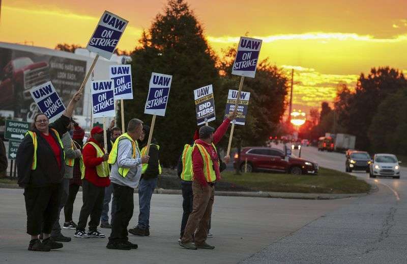 United Auto Workers Local 862 members strike outside of Ford's Kentucky Truck Plant in Louisville, Ky., on Thursday. The United Auto Workers union significantly escalated its walkout against Detroit's Three automakers, shutting down Ford's largest factory and threatening Jeep maker Stellantis.