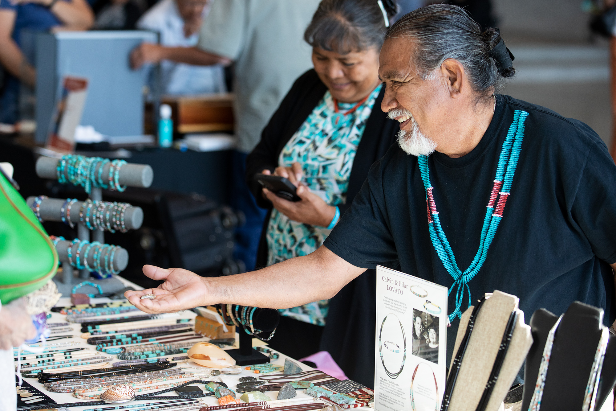 Calvin and Pilar Lovato of the Santo Domingo Pueblo sell traditional and contemporary heihsi jewelry made of natural stone and shells at the 2022 Indigenous Art Market at the Natural History Museum of Utah in Salt Lake City.