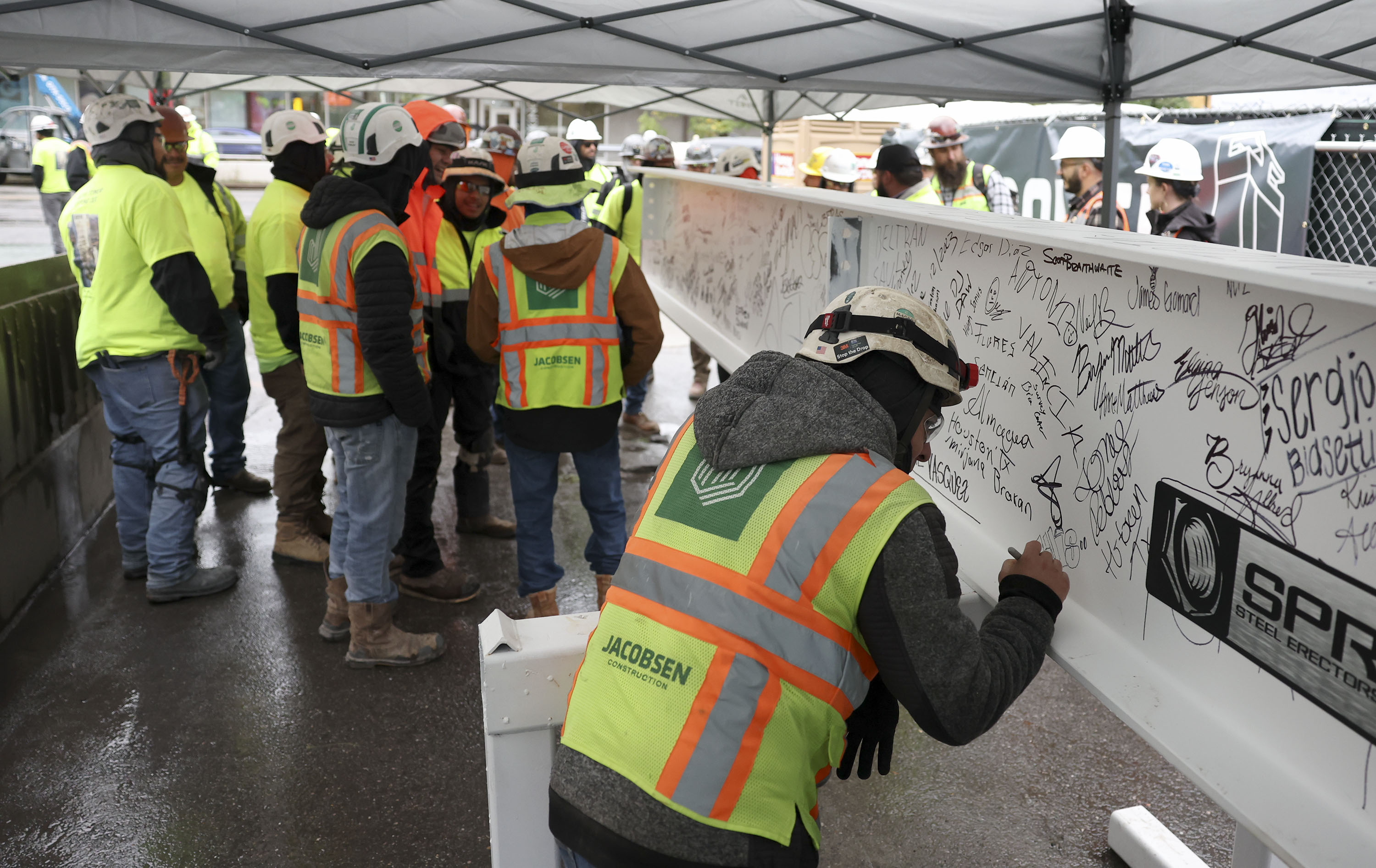 Construction workers sign the final steel beam before its ceremonial placement atop the 40th floor of Astra Tower in Salt Lake City on Thursday. The 40-story tower in Salt Lake City's downtown will be Utah’s tallest high-rise at 450 feet.