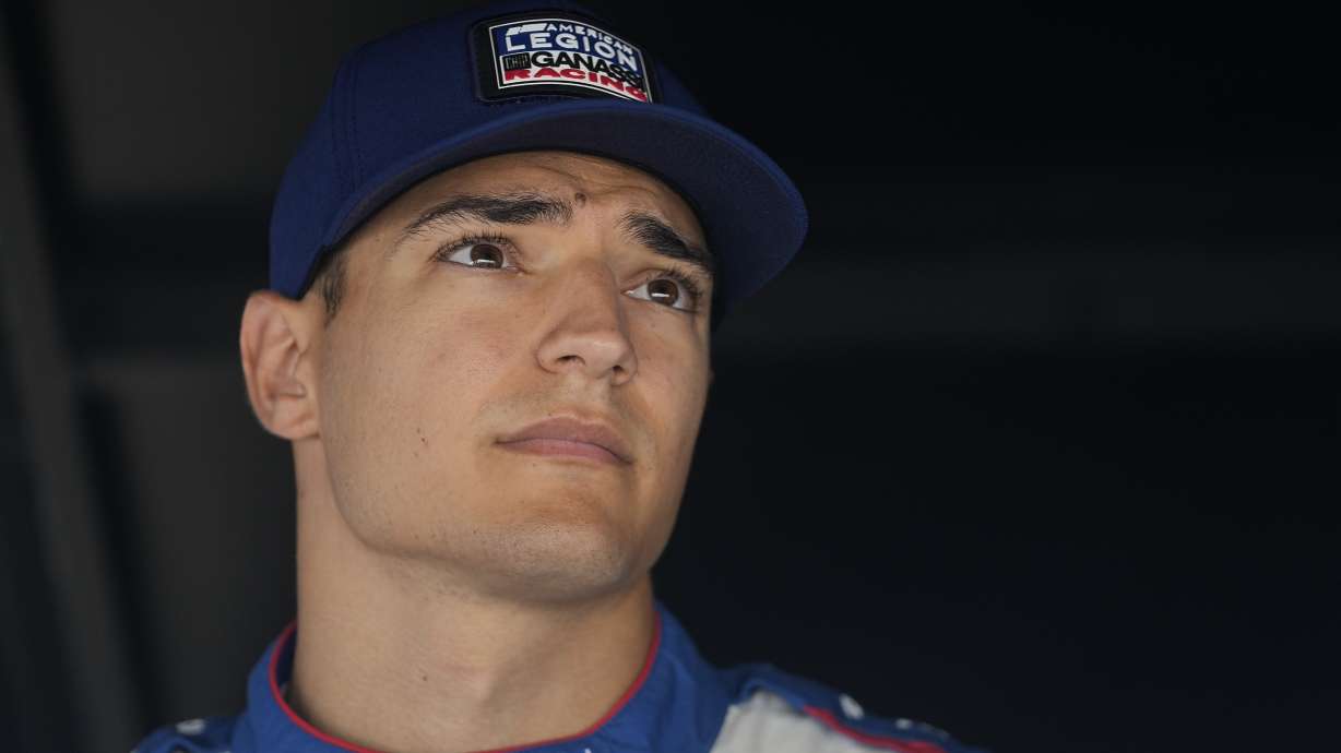 FILE - Alex Palou sits in his pit box during a practice session for the IndyCar Indianapolis GP auto race at Indianapolis Motor Speedway, Friday, Aug. 11, 2023, in Indianapolis. McLaren Racing is suing IndyCar champion Alex Palou for at least $23 million in damages — $400,000 of which is a salary advance paid to the Spaniard — over Palou's decision not to honor the contract he signed to join the team at the end of last month.