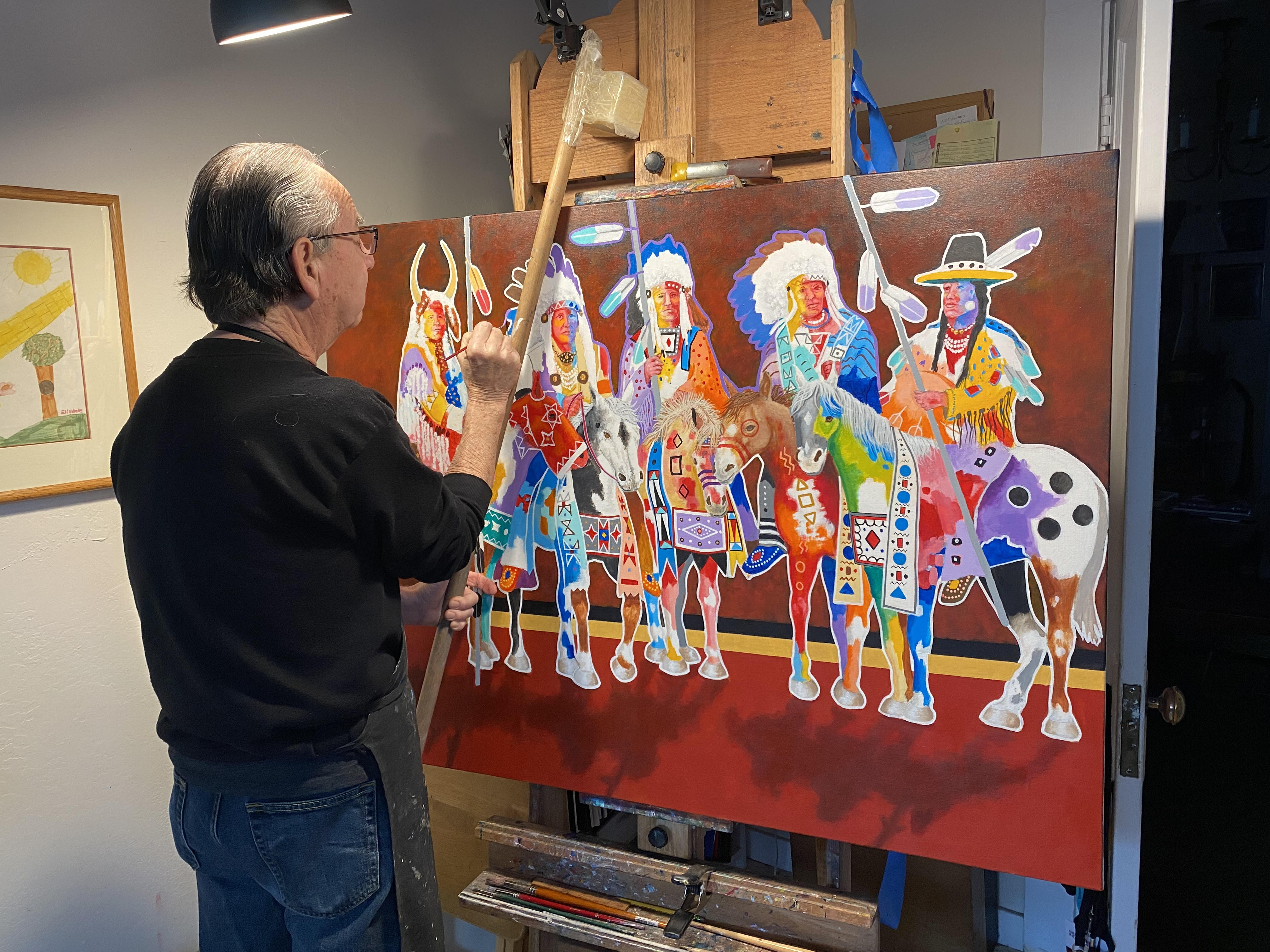 John Balloue works on a painting. Balloue will be one of dozens of Indigenous artists at the Utah Natural History Museum's Indigenous Art Market this weekend.