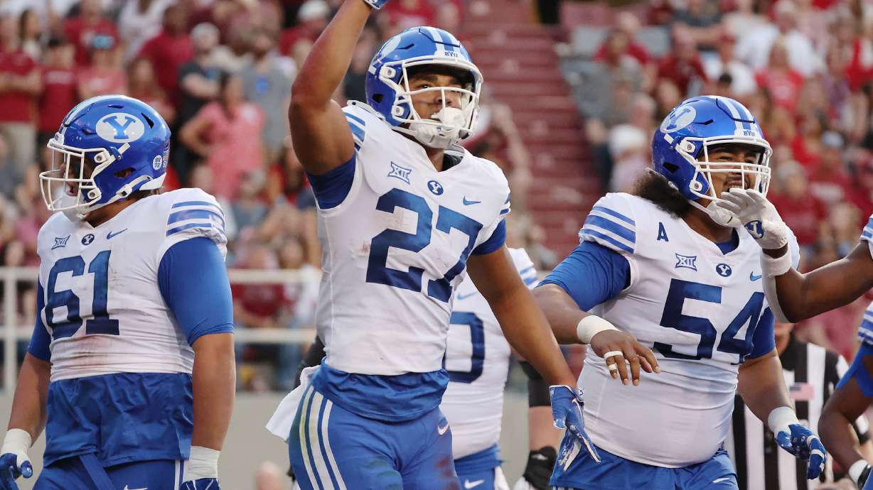Brigham Young running back LJ Martin (27) celebrates his touchdown against the Arkansas Razorbacks at Razorback Stadium in Fayetteville on Saturday, Sept. 16, 2023.