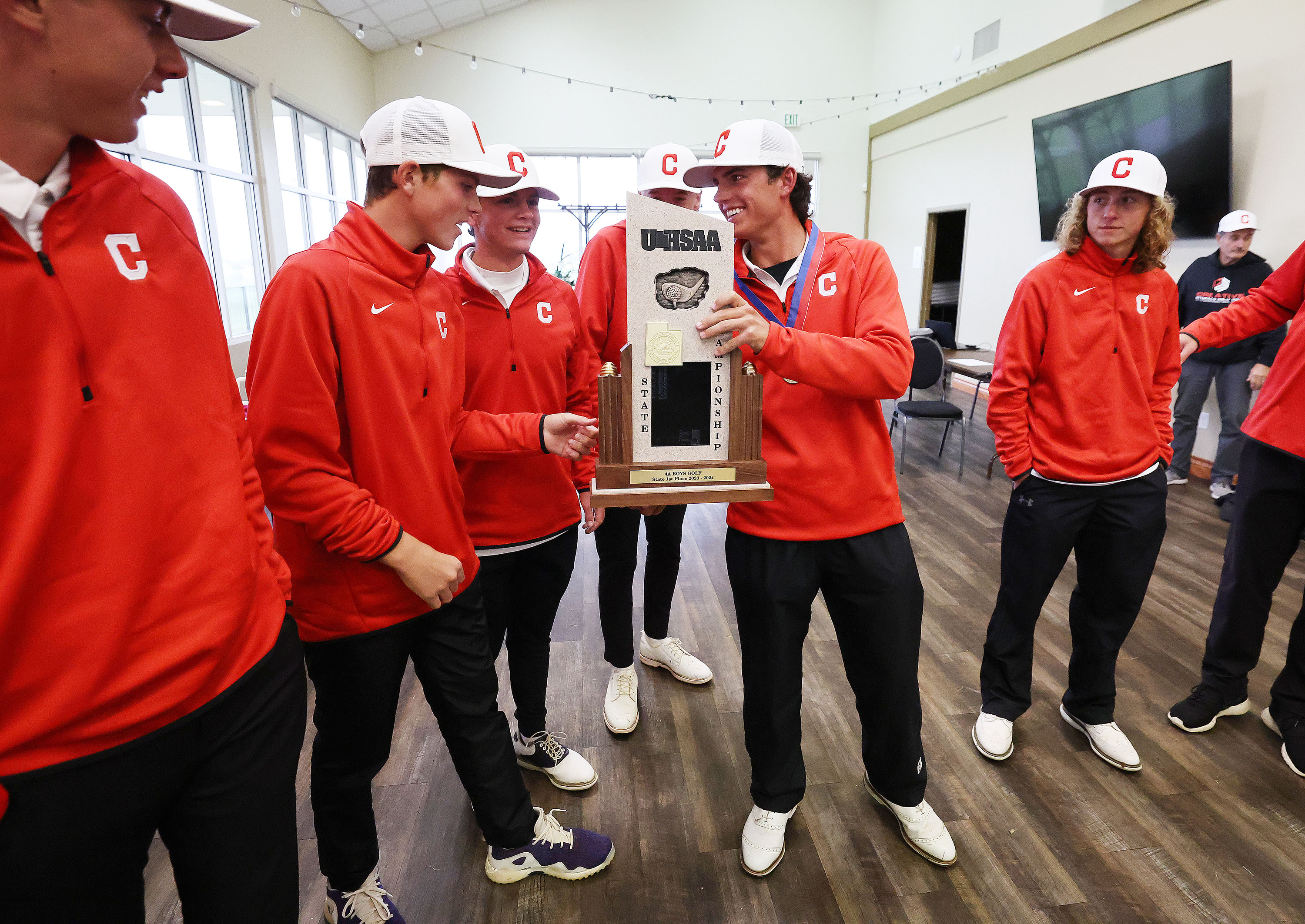 Crimson Cliffs players celebrate their win in the team championship during the 4A boys golf tournament at The Ridge Golf Club in West Valley City on Thursday, Oct. 12, 2023.