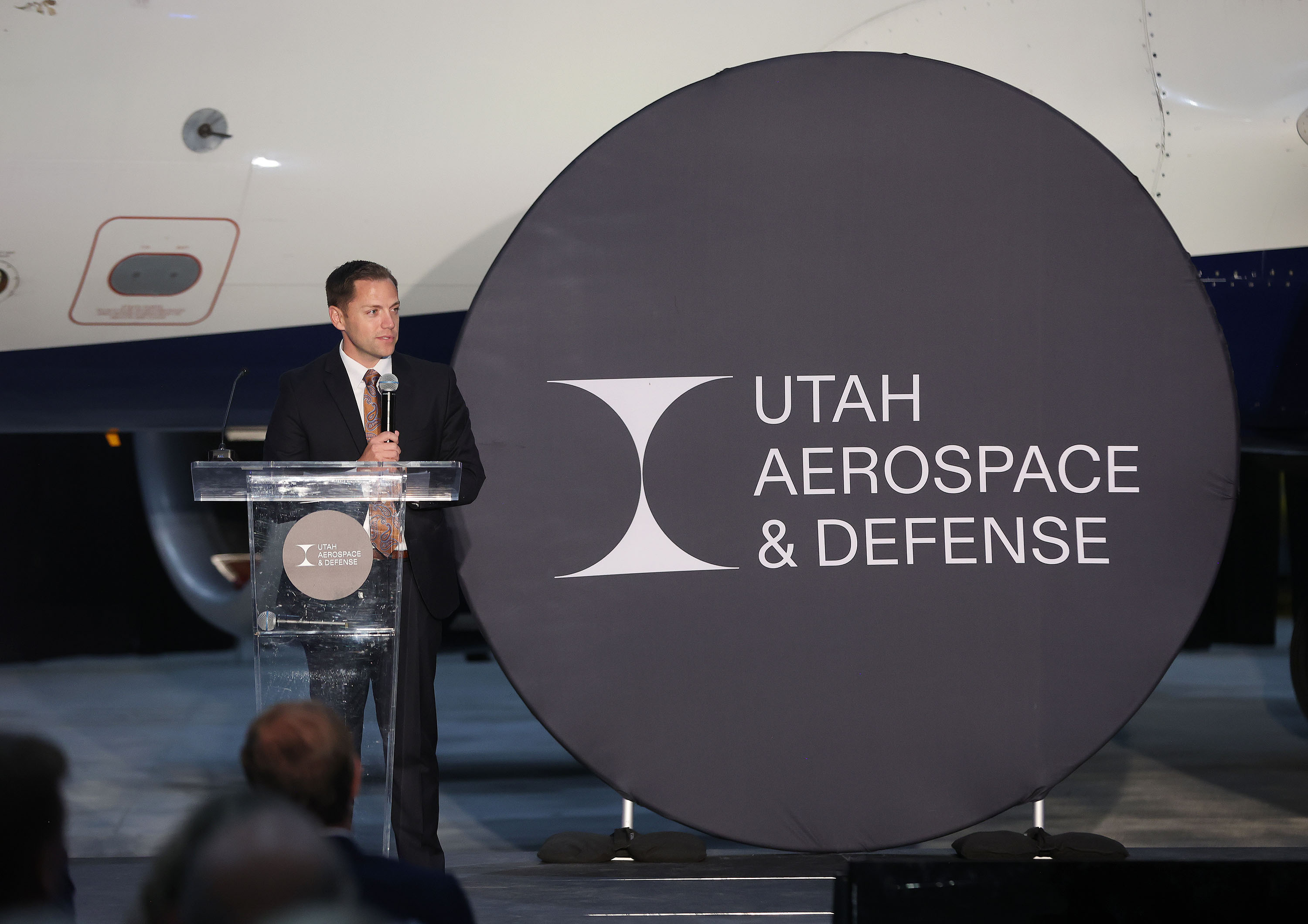 Aaron Starks, President & CEO of Utah Aerospace & Defense, speaks at the Delta hangar in Salt Lake City on Thursday as Utah Aerospace and Defense invests in artificial intelligence and semiconductor research and rebrands.