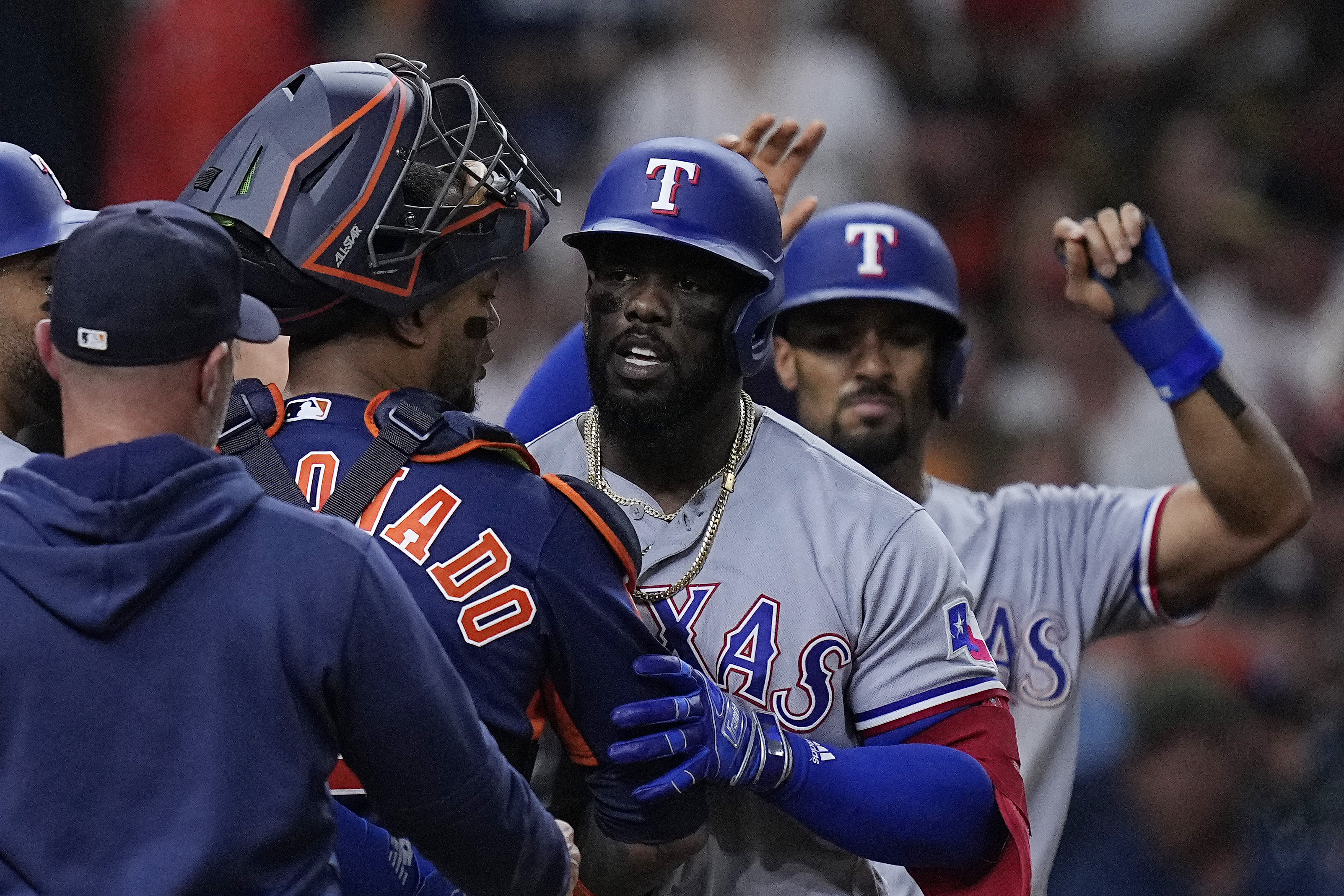 FILE - Houston Astros catcher Martin Maldonado and Texas Rangers' Adolis Garcia, second from right, argue as the benches clear following Garcia's grand slam during the fifth inning of a baseball game July 26, 2023, in Houston. Everything is certainly bigger deep in the heart of Texas this baseball postseason, with a Lone Star State matchup for a spot in the World Series. The Astros are in their seventh straight ALCS, this time against the Rangers for the first time.