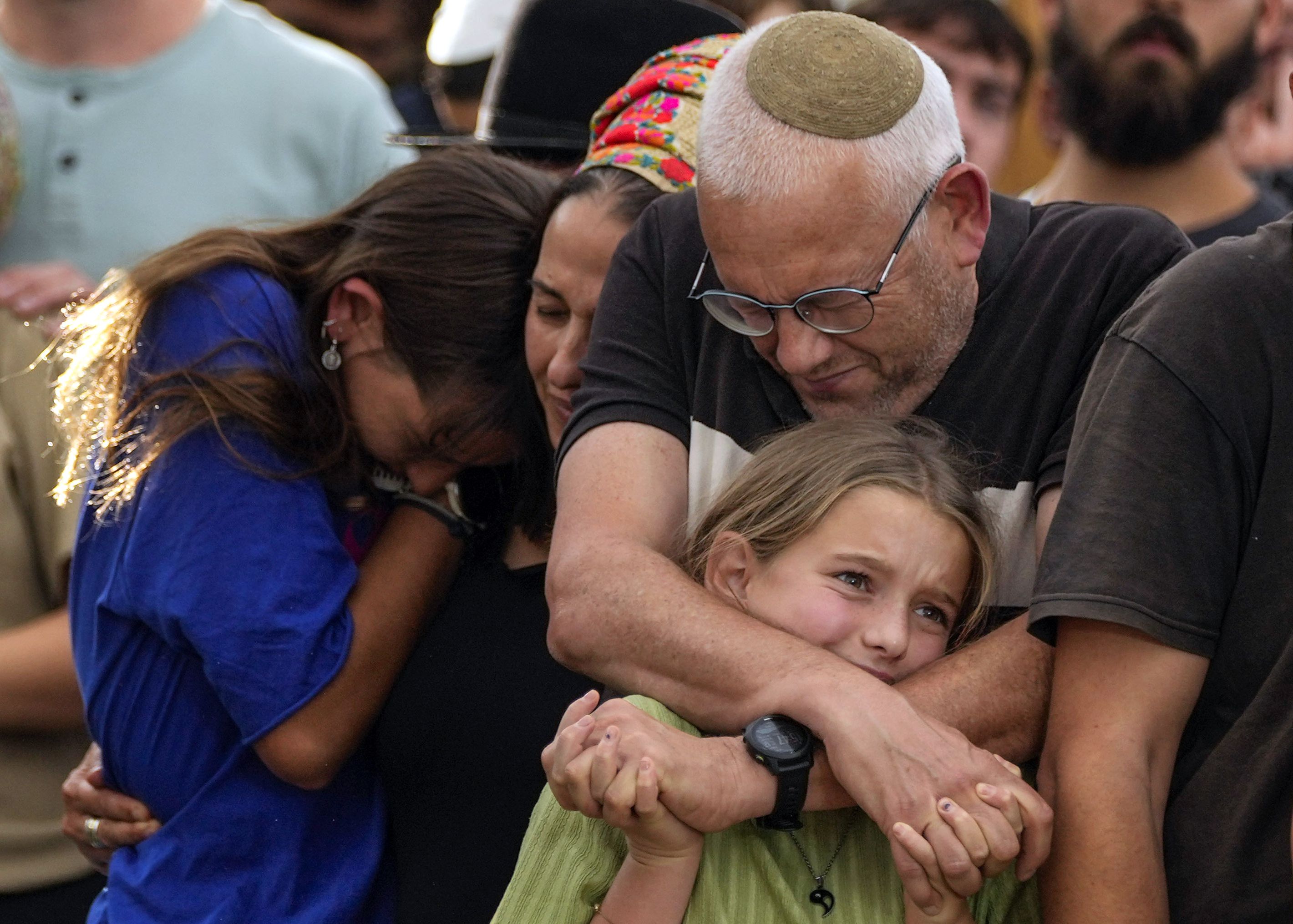 Family members mourn during the funeral of Israeli soldier Shilo Rauchberger at the Mount Herzl cemetery in Jerusalem, Israel, on Thursday. Some suggest deleting social media accounts to protect kids from gruesome images.