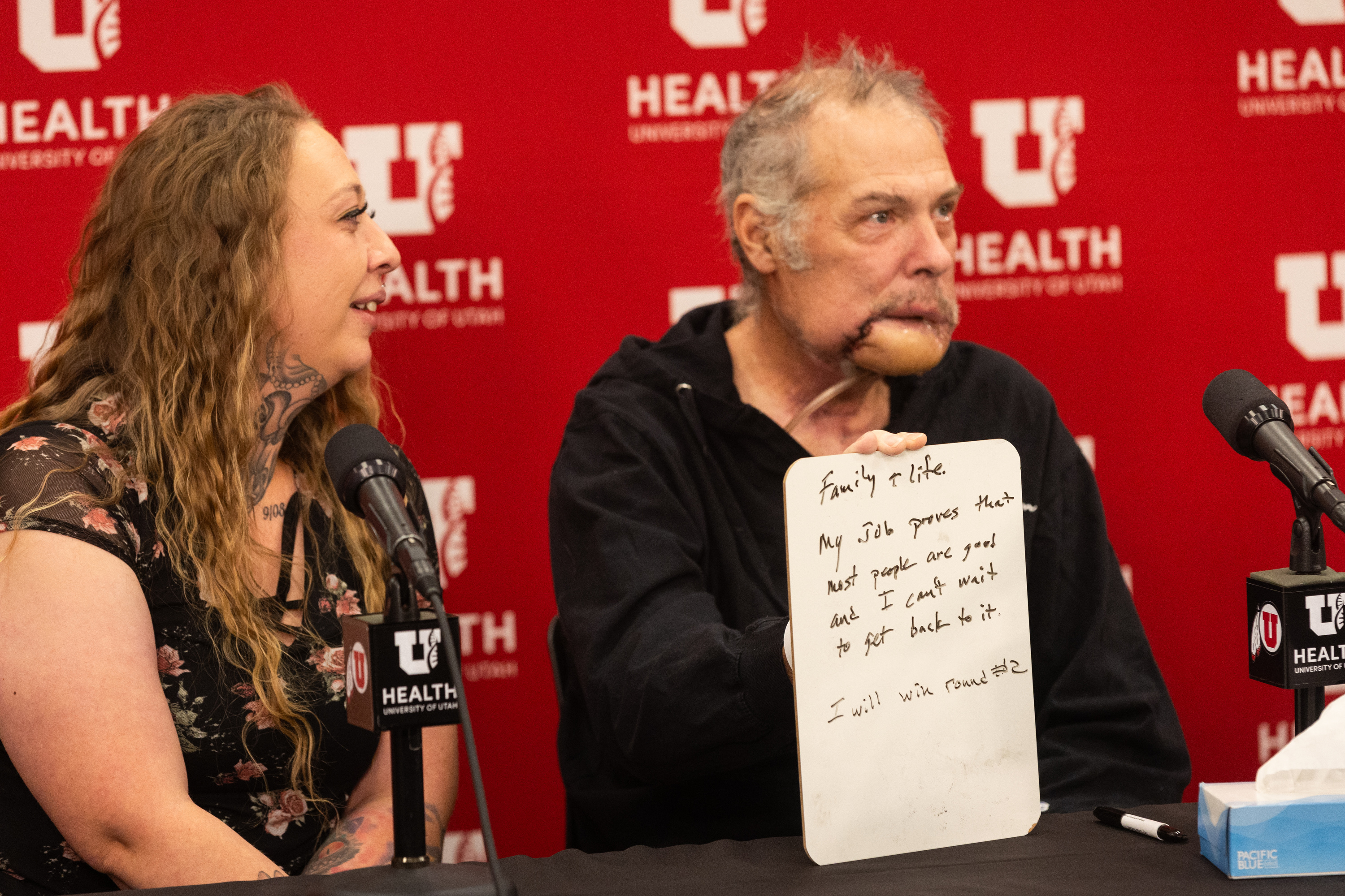 Rudy Noorlander holds up a whiteboard answering the question about what has kept him going as he has recovered from a grizzly bear attack at a press conference at University of Utah Hospital in Salt Lake City on Friday. Noorlander was attacked by a grizzly bear on Sept. 8 in Big Sky, Montana. After emergency surgery in Bozeman, Noorlander was flown to University of Utah Hospital where he has continued his care. His daughter Ashley Noorlander is at left.