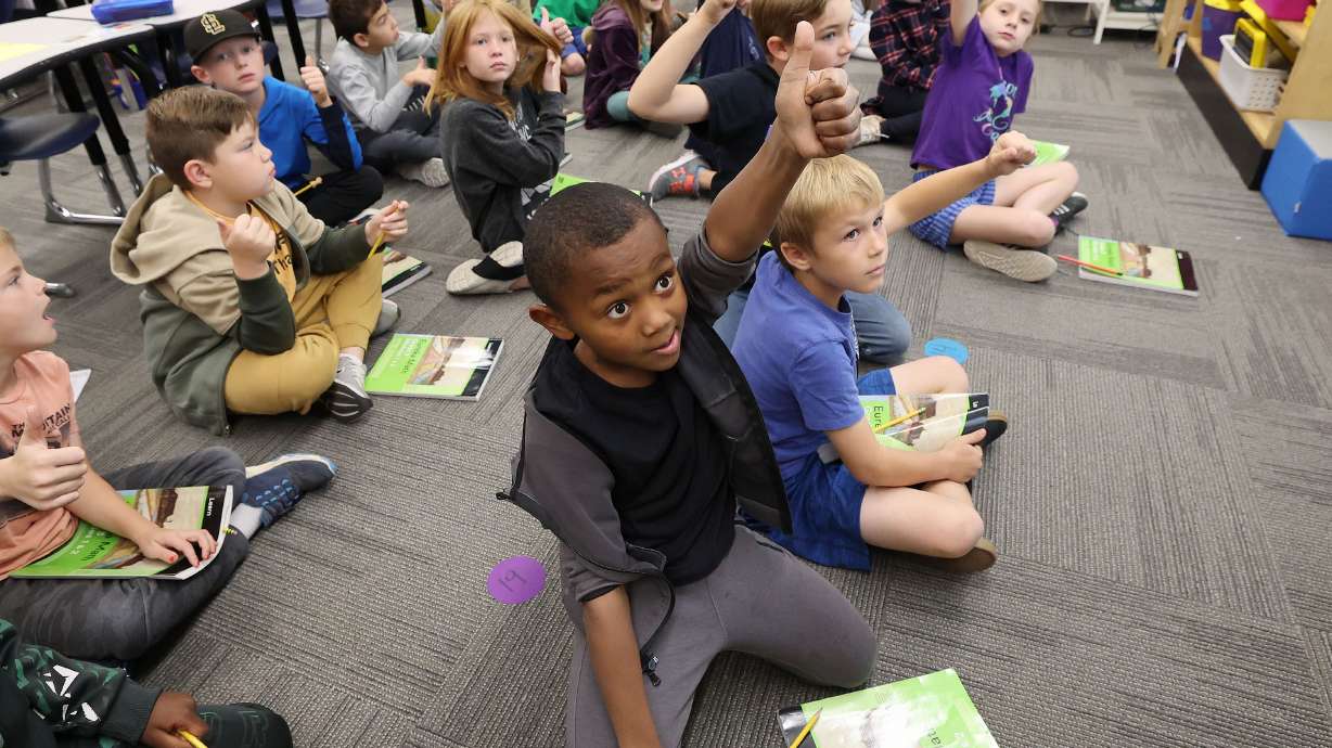 Wasatch Elementary School third grader Mounir Johnson gives a thumbs-up in class in Salt Lake City on Tuesday. The school was designated a Blue Ribbon School by the U.S. Department of Education.