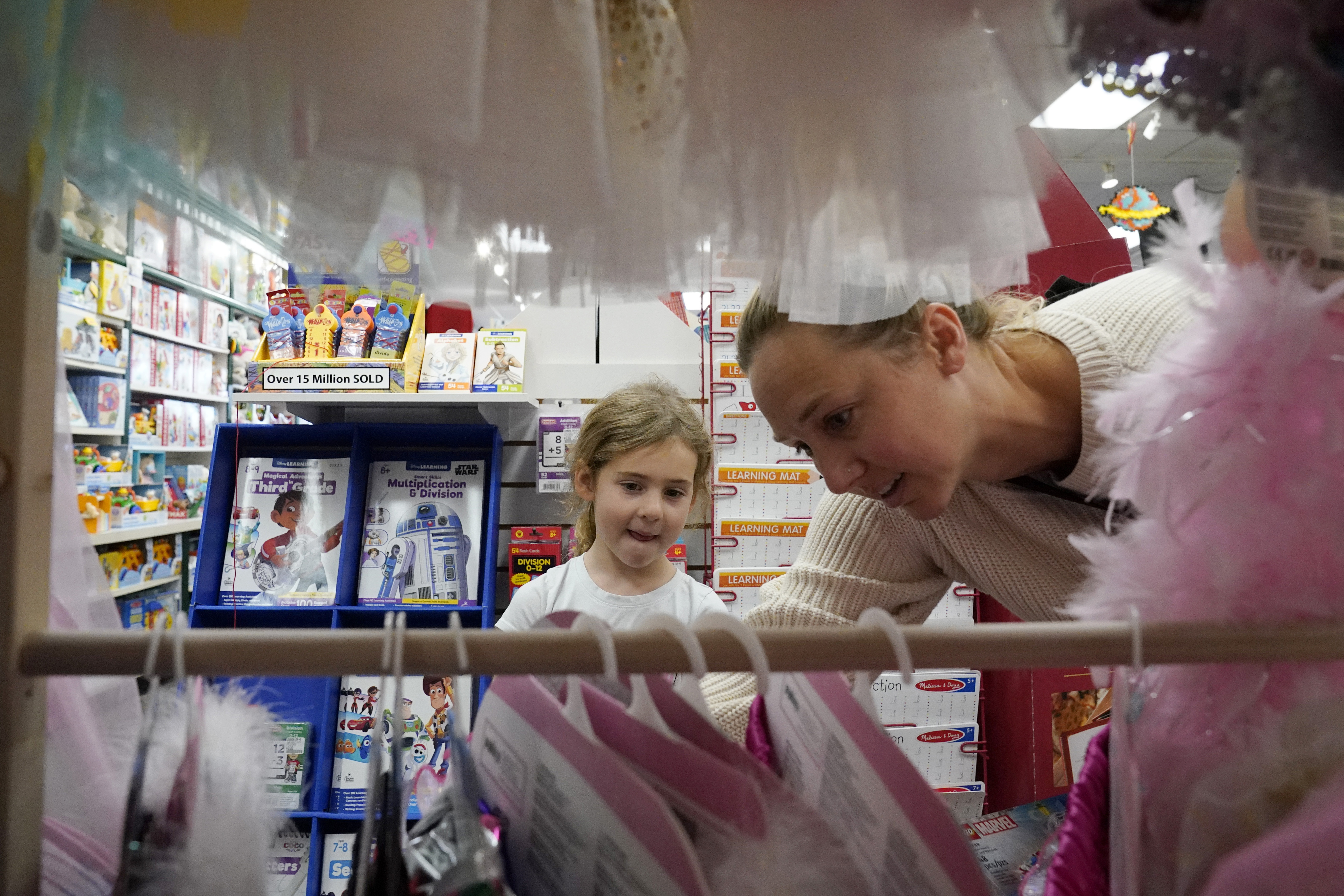 Quinn Byrne, 5 left, shops with her mother, Jamie Byrne, at a Learning Express store in Lake Zurich, Ill., Sept. 26. A growing number of toy marketers are embracing new designation of toys that teach kids skills like how to adjust to new challenges. 