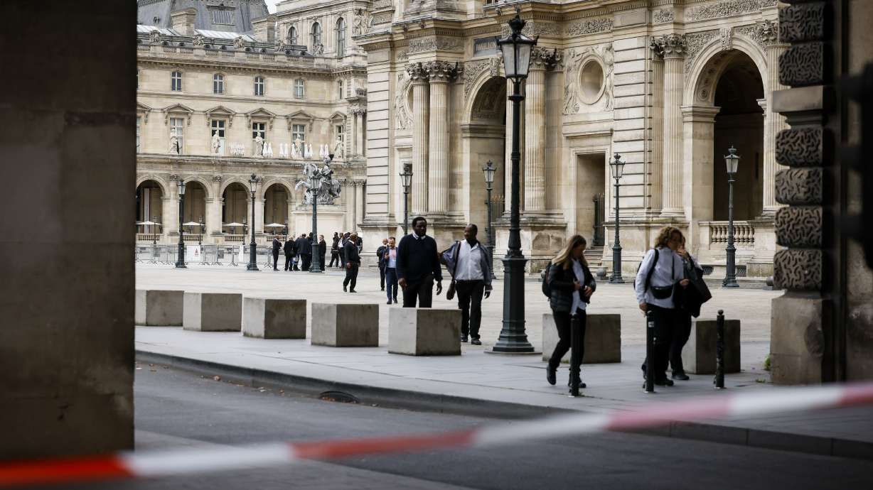 Staff leave the Louvre Museum as people are evacuated after it received a written threat, in Paris, Saturday. The Louvre Museum says it is closing for the day and evacuating all visitors and staff after a threat.