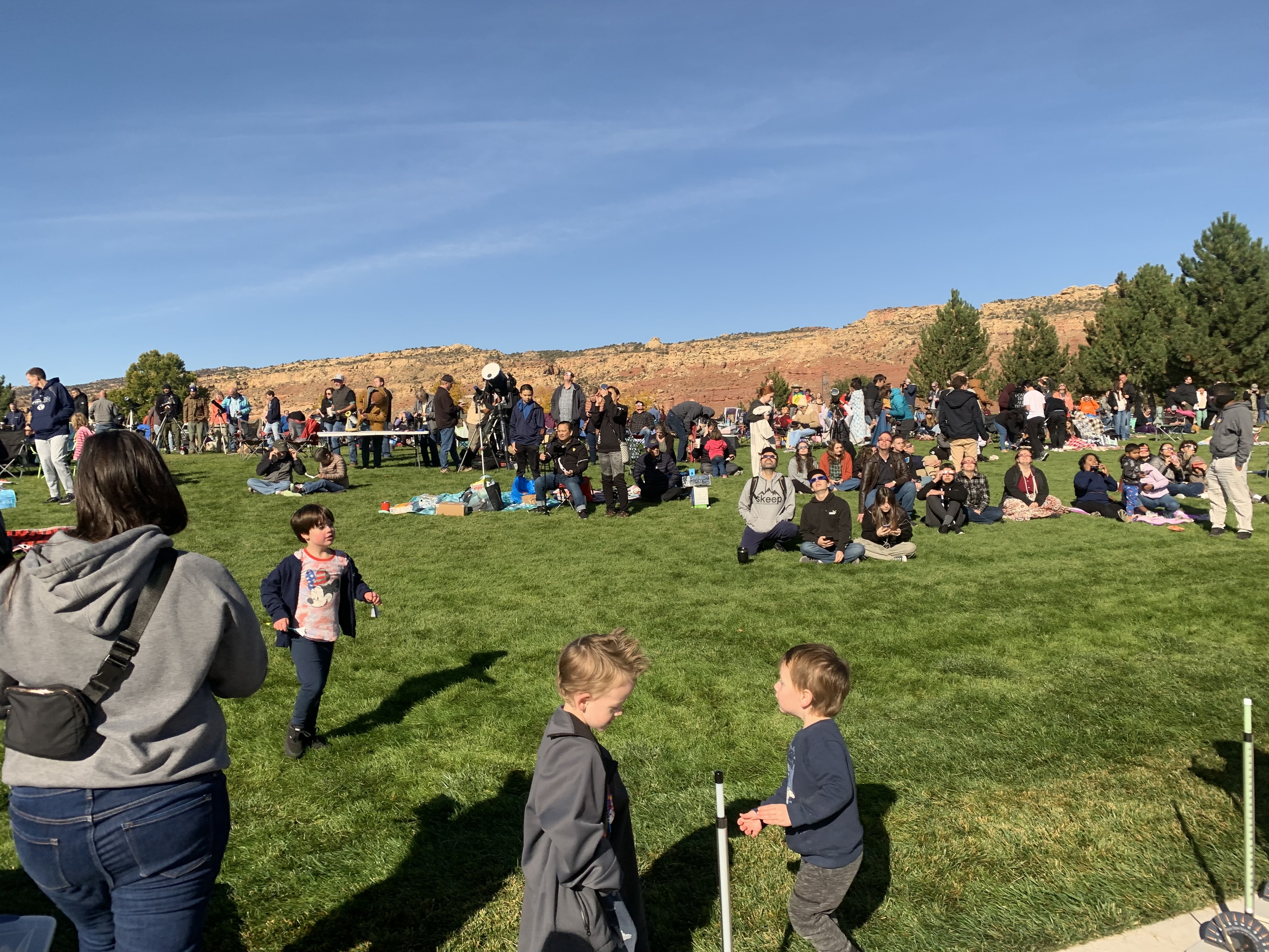People watch the annular solar eclipse at Snow College's Richfield campus on Saturday.