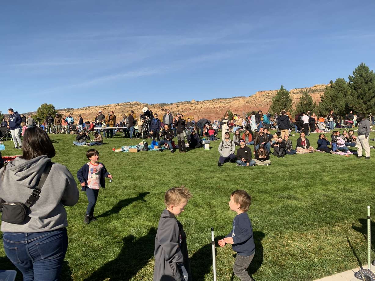 People watch the annular solar eclipse at Snow College's Richfield campus on Saturday.