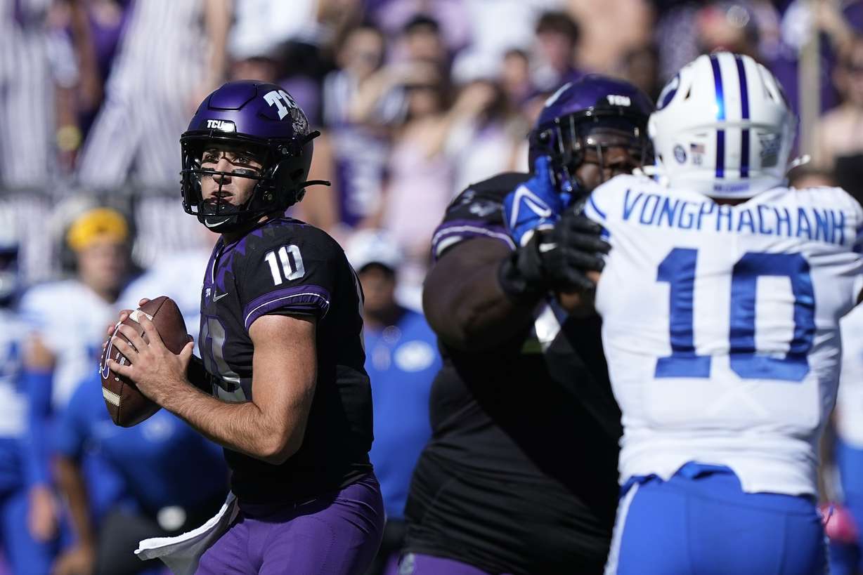 TCU quarterback Josh Hoover (10) looks to pass with blocking against BYU linebacker AJ Vongphachanh (10) during the first half of an NCAA college football game Saturday, Oct. 14, 2023, in Fort Worth, Texas.
