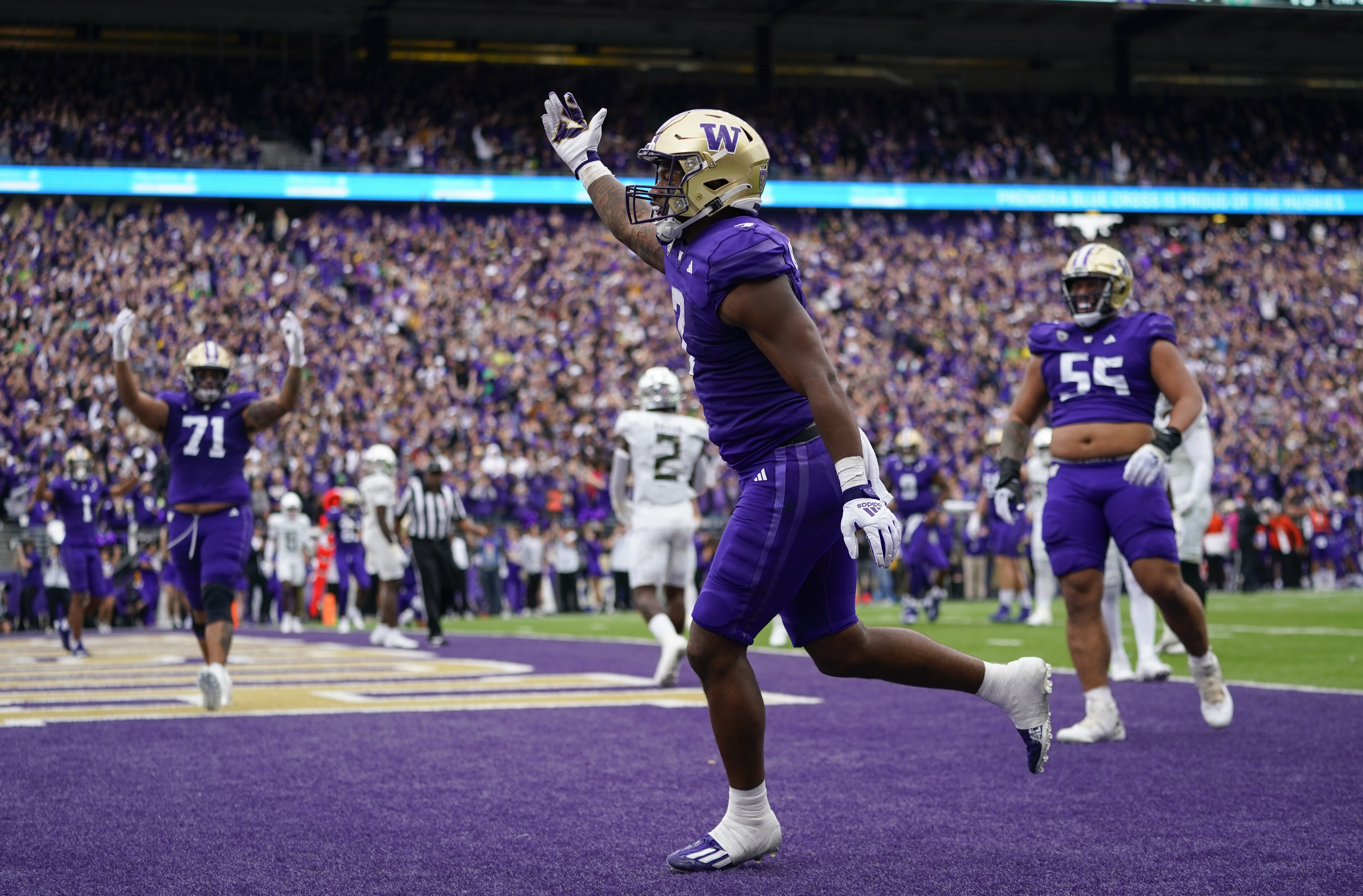 Washington running back Dillon Johnson reacts after scoring a touchdown against Oregon during the first half of an NCAA college football game, Saturday, Oct. 14, 2023, in Seattle. 