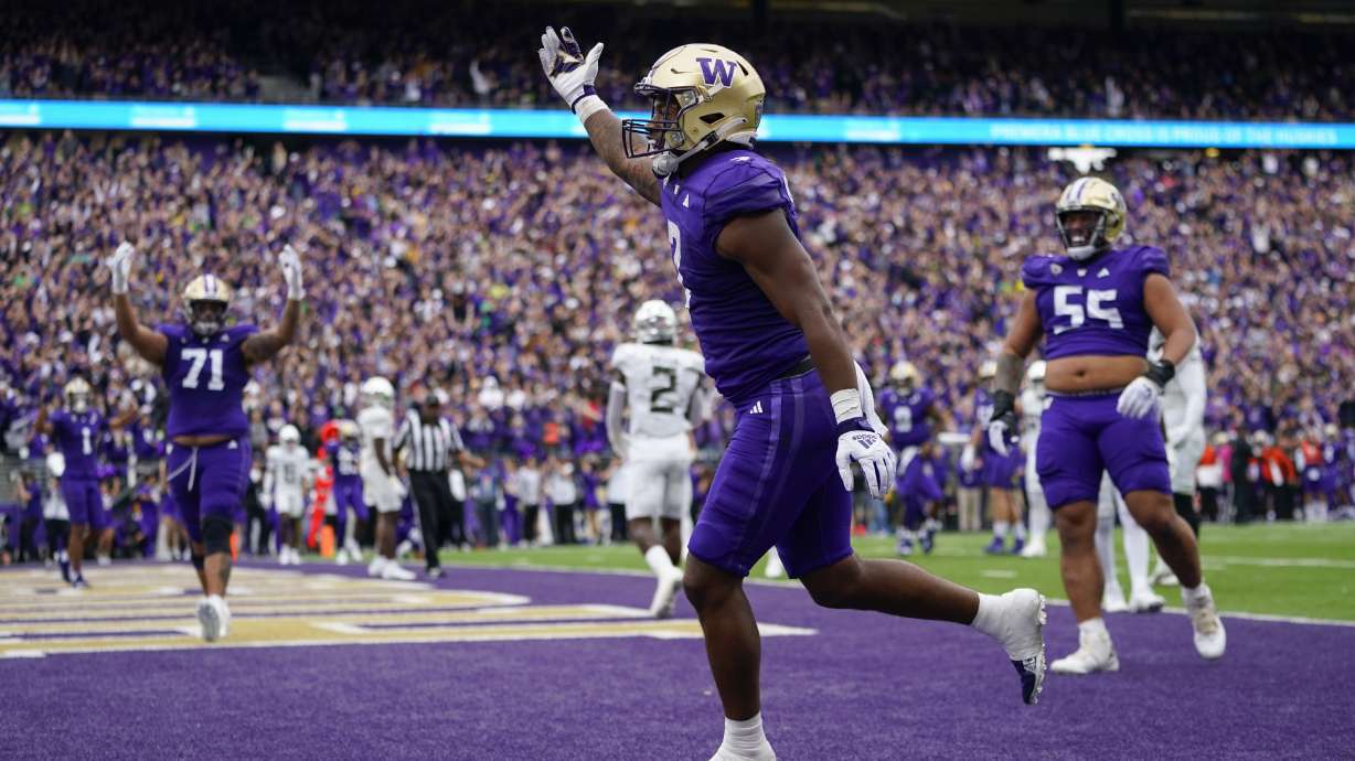 Washington running back Dillon Johnson reacts after scoring a touchdown against Oregon during the first half of an NCAA college football game, Saturday, Oct. 14, 2023, in Seattle.