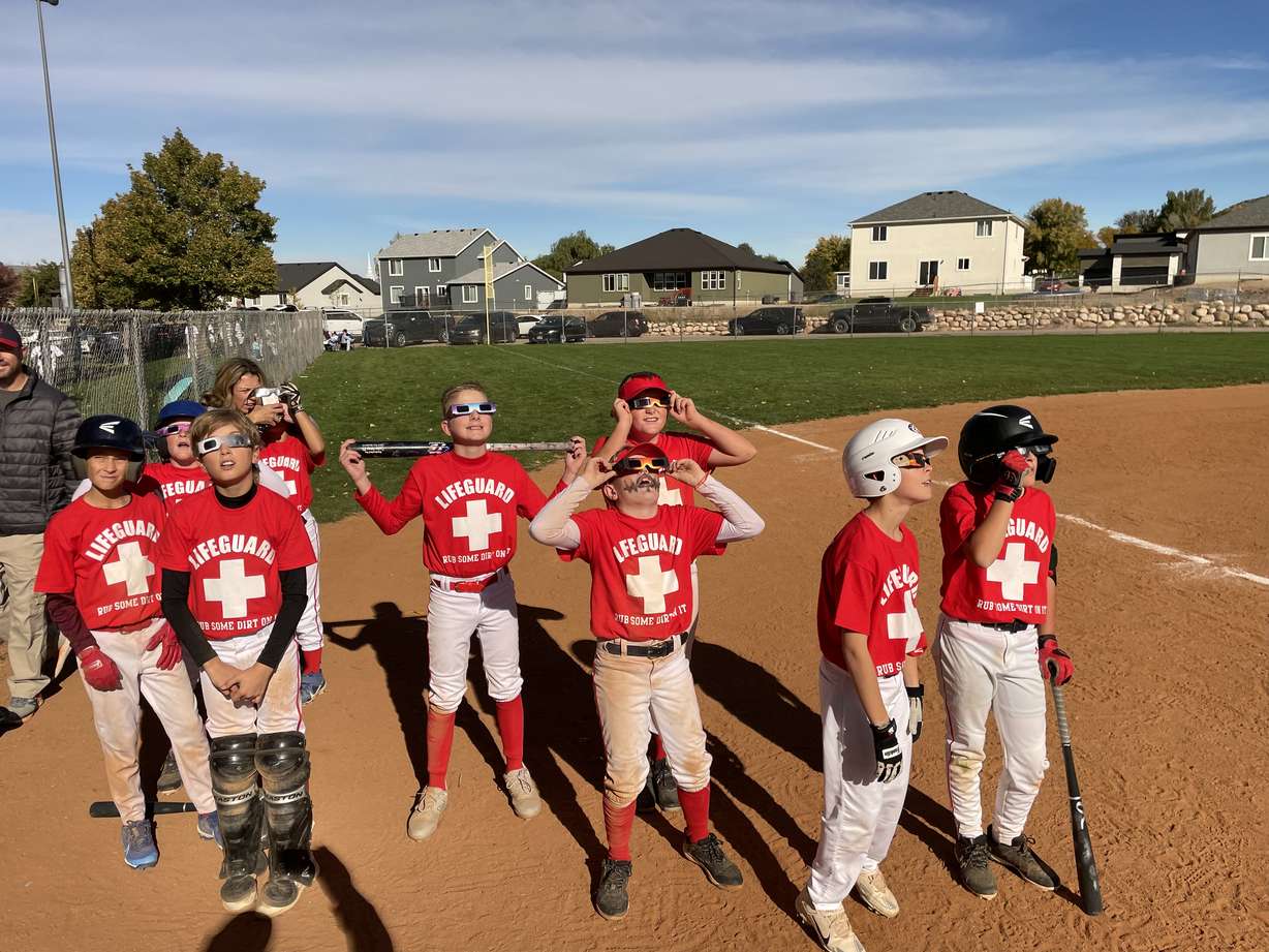 A little league baseball team in Nephi briefly paused on the field to watch the annular eclipse on Saturday.