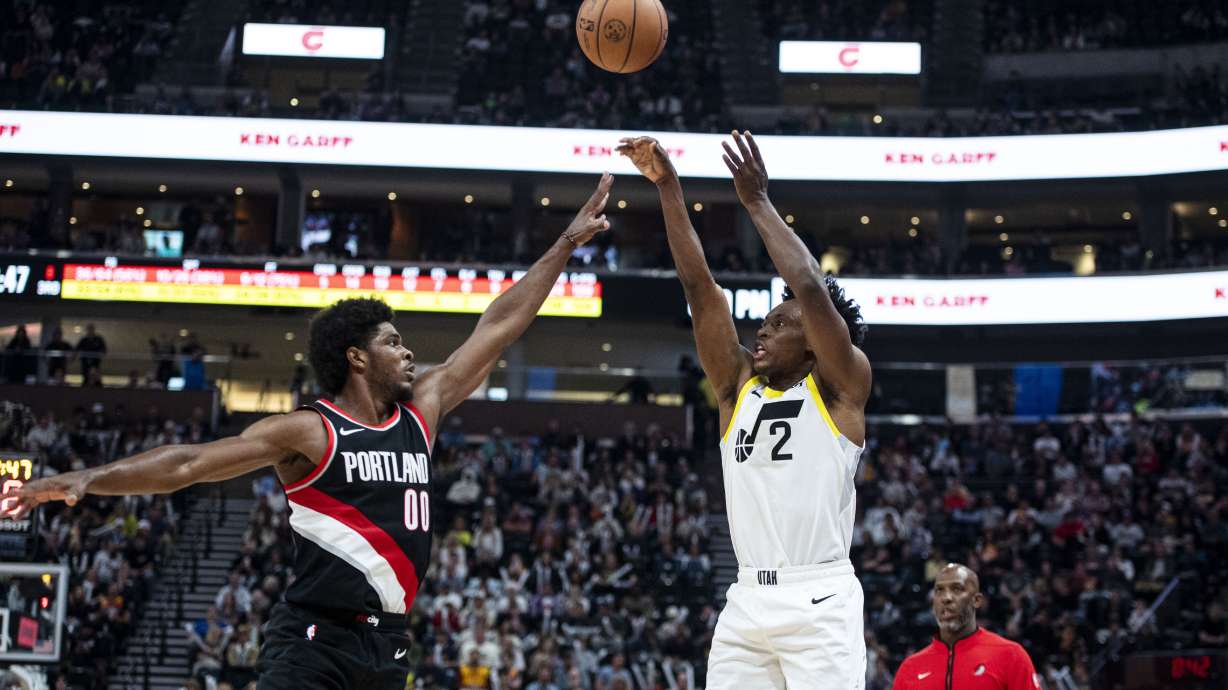 Utah Jazz guard Collin Sexton (2) shoots the ball past Portland Trail Blazers guard Scoot Henderson (00) during the second half of an NBA preseason basketball game Saturday, Oct. 14, 2023, in Salt Lake City.