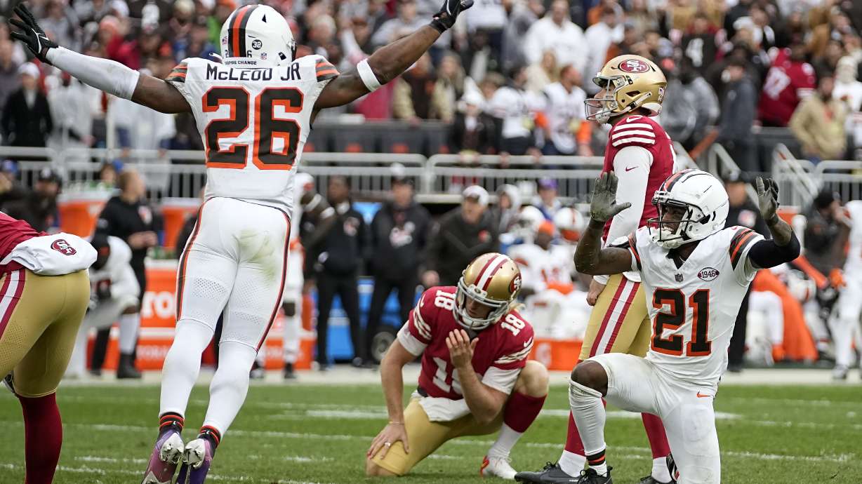 San Francisco 49ers place kicker Jake Moody, top right, and Mitch Wishnowsky (18) react as Cleveland Browns' Rodney McLeod Jr. (26) and Denzel Ward (21) celebrate after Moody missed a field goal during the second half of an NFL football game Sunday, Oct. 15, 2023, in Cleveland.