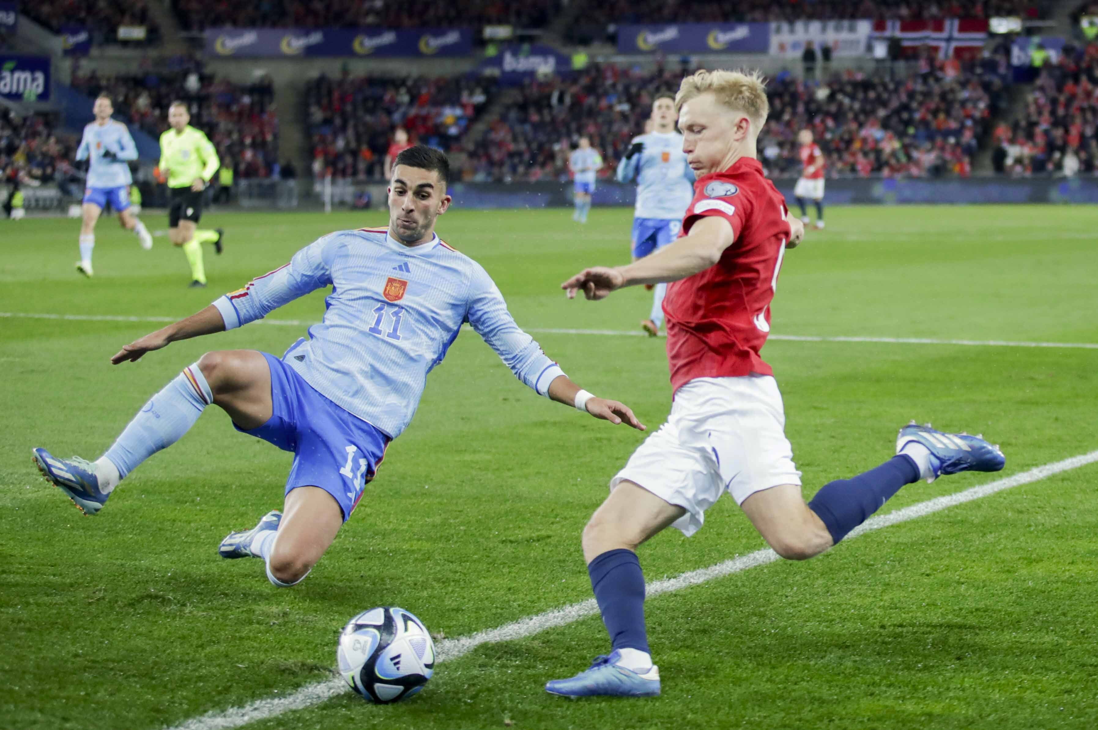 Spain's Ferran Torres, left, and Norway's Birger Meling fight for the ball during the Euro 2024 group A qualifying soccer match between Norway and Spain at the Ullevaal Stadium in Oslo, Norway, Sunday Oct. 15, 2023.