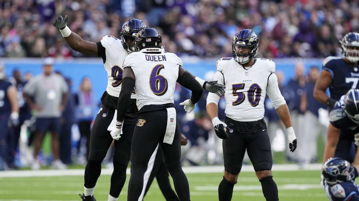 Baltimore Ravens defensive tackle Justin Madubuike (92), Baltimore Ravens linebacker Patrick Queen (6), and Baltimore Ravens linebacker Kyle Van Noy (50) celebrate after a play during an NFL football game between the Tennessee Titans and the Baltimore Ravens at Tottenham Hotspur Stadium in London, Sunday, Oct. 15, 2023.