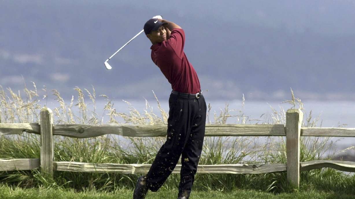 FILE - Tiger Woods drives the 18th hole on his way to winning the 100th U.S. Open Golf Championship at the Pebble Beach Golf Links in Pebble Beach, Calif., on June 18, 2000. A 60-foot birdie putt sunk on the 18th at St. Andrew’s before a playoff loss to John Daly at the 1995 British Open. A front-row seat to history paired with Tiger Woods in the final round of the 1997 Masters. Then a career-defining singles win over Woods later in ’97 that helped Europe win the Ryder Cup. It’s been nearly three decades since Costantino Rocca put Italian golf on the map and it’s hard to imagine the Ryder Cup being held near Rome this week would have happened without him.