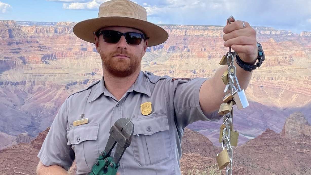 A Grand Canyon National Park ranger holds up padlocks that were removed from the park. Park officials are urging visitors to not leave "love locks" in the park after a recent uptick in the practice.