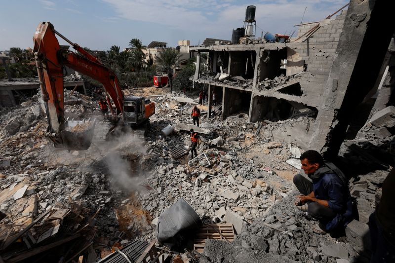 Palestinians search for casualties under the rubble at a site of a house destroyed by Israeli strikes in Khan Younis in the southern Gaza Strip on Monday.