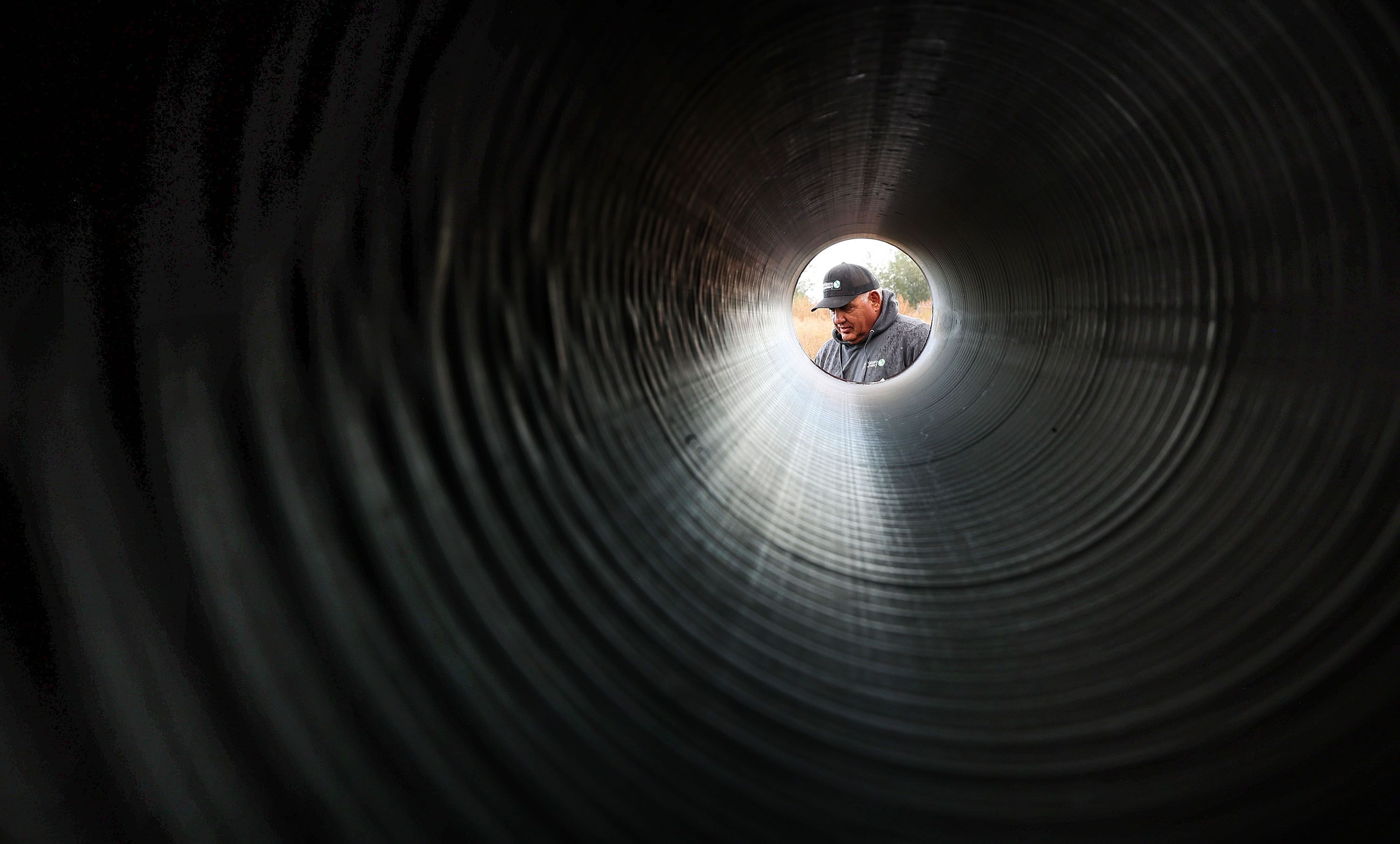Salt Lake Shoreland manager Mike Kolendrianos looks over irrigation pipes being installed to replace ditches on the New Harvey pastures in Davis County on Oct. 11. 