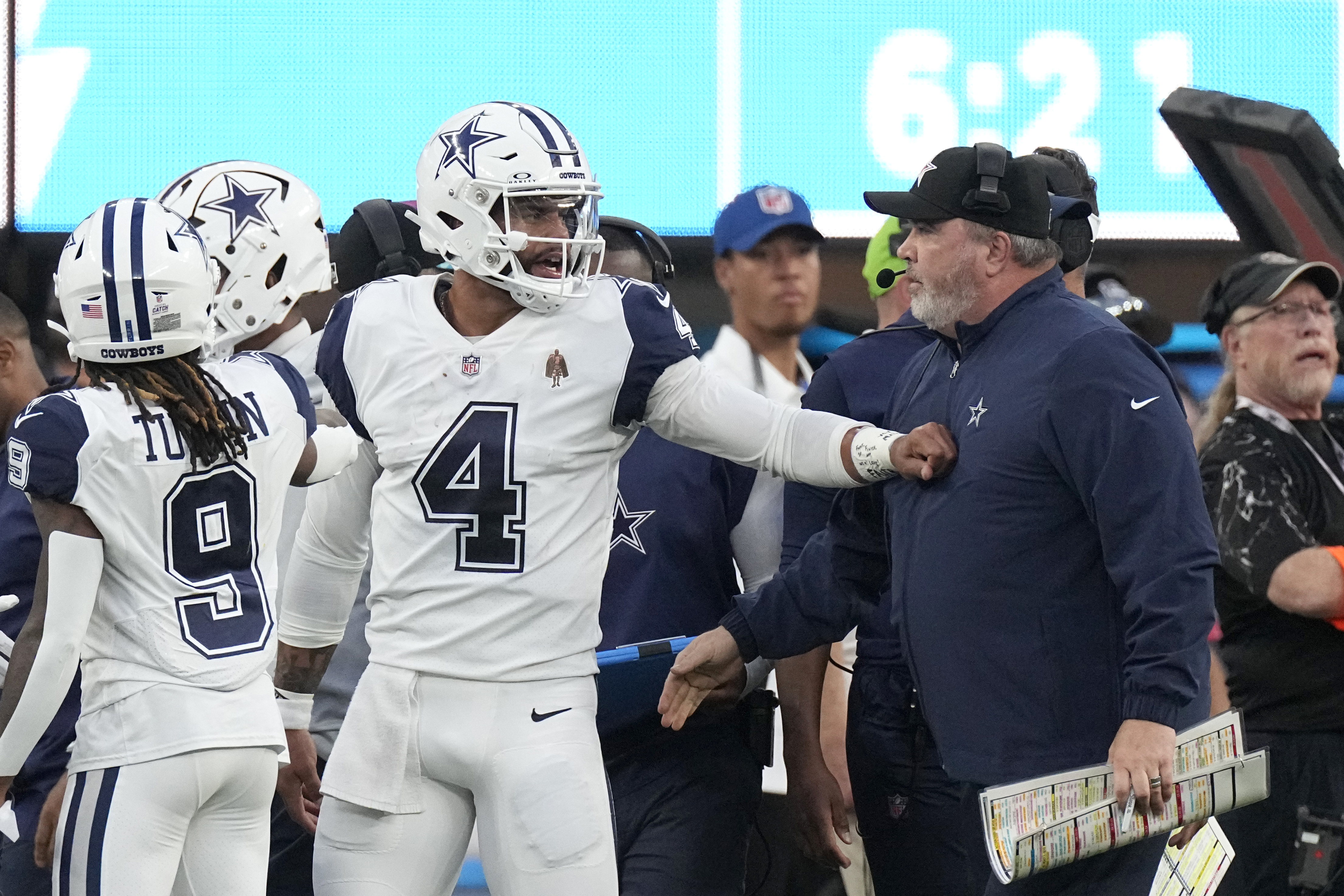 Dallas Cowboys quarterback Dak Prescott (4) talks with Cowboys head coach Mike McCarthy, right, during the first half of an NFL football game against the Los Angeles Chargers, Monday, Oct. 16, 2023, in Inglewood, Calif.