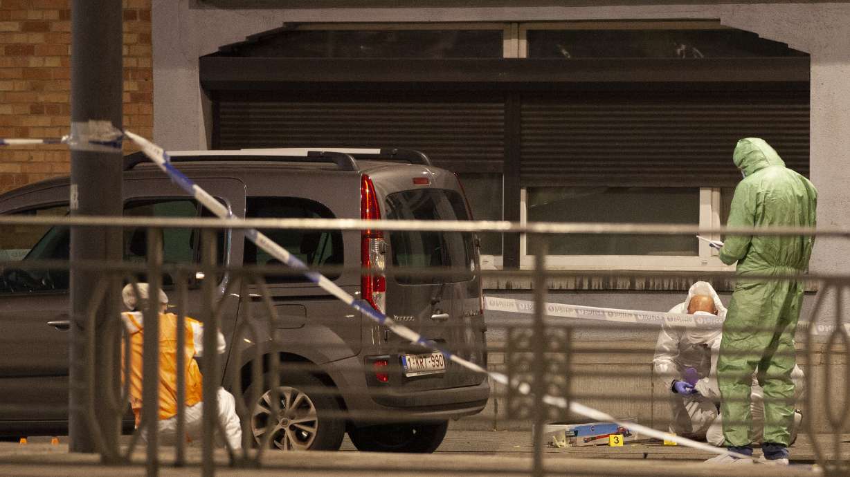 Police and inspectors work in an area where a shooting took place in the center of Brussels, Monday, Oct. 16, 2023. Belgian police say that two people are dead in central Brussels after several shots were fired.