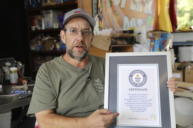 Ed Currie holds up his certification that his new Pepper X variety of peppers is the hottest in the world according to the Guinness Book of World Records on Oct. 10 in Fort Mill, S.C.