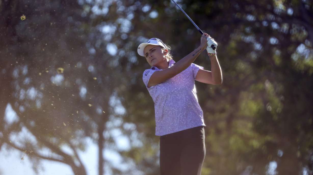 Lexi Thompson follows through with her tee shot on the eighth hole during the first day of the Shriners Children's Open golf tournament, Thursday, Oct. 12, 2023, in Las Vegas.