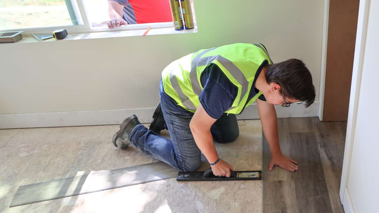 Davis Technical College student Jonathan Hanson works on the flooring of a home his class is helping to build in Ogden last winter. Building the house is part of the construction and plumbing programs at Davis Tech.